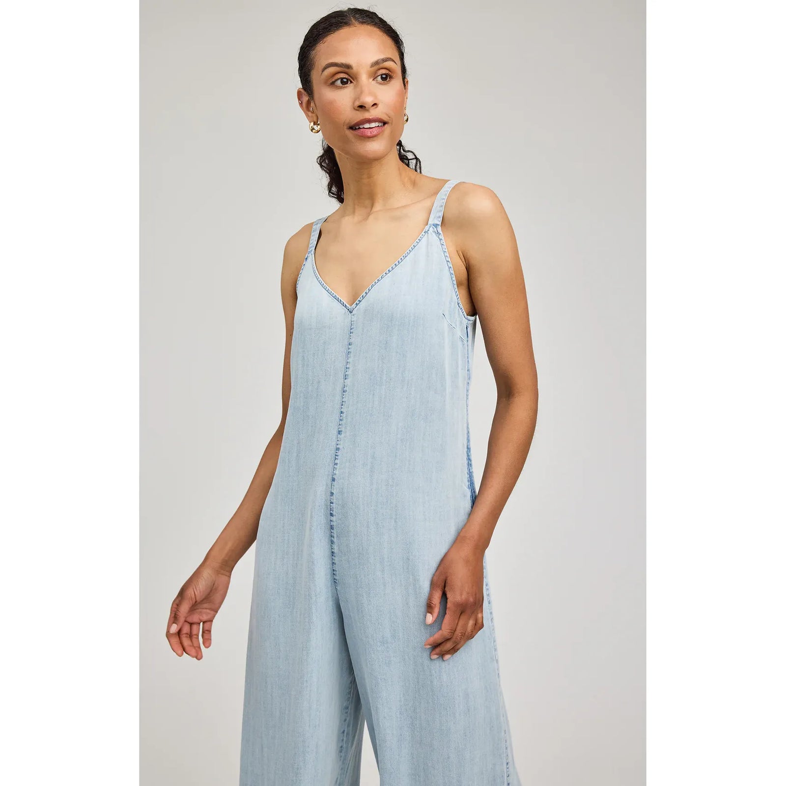 Gentle Fawn Cambry Jumpsuit in light denim, V-neck straps, wide-leg silhouette, textured soft Tencel fabric.