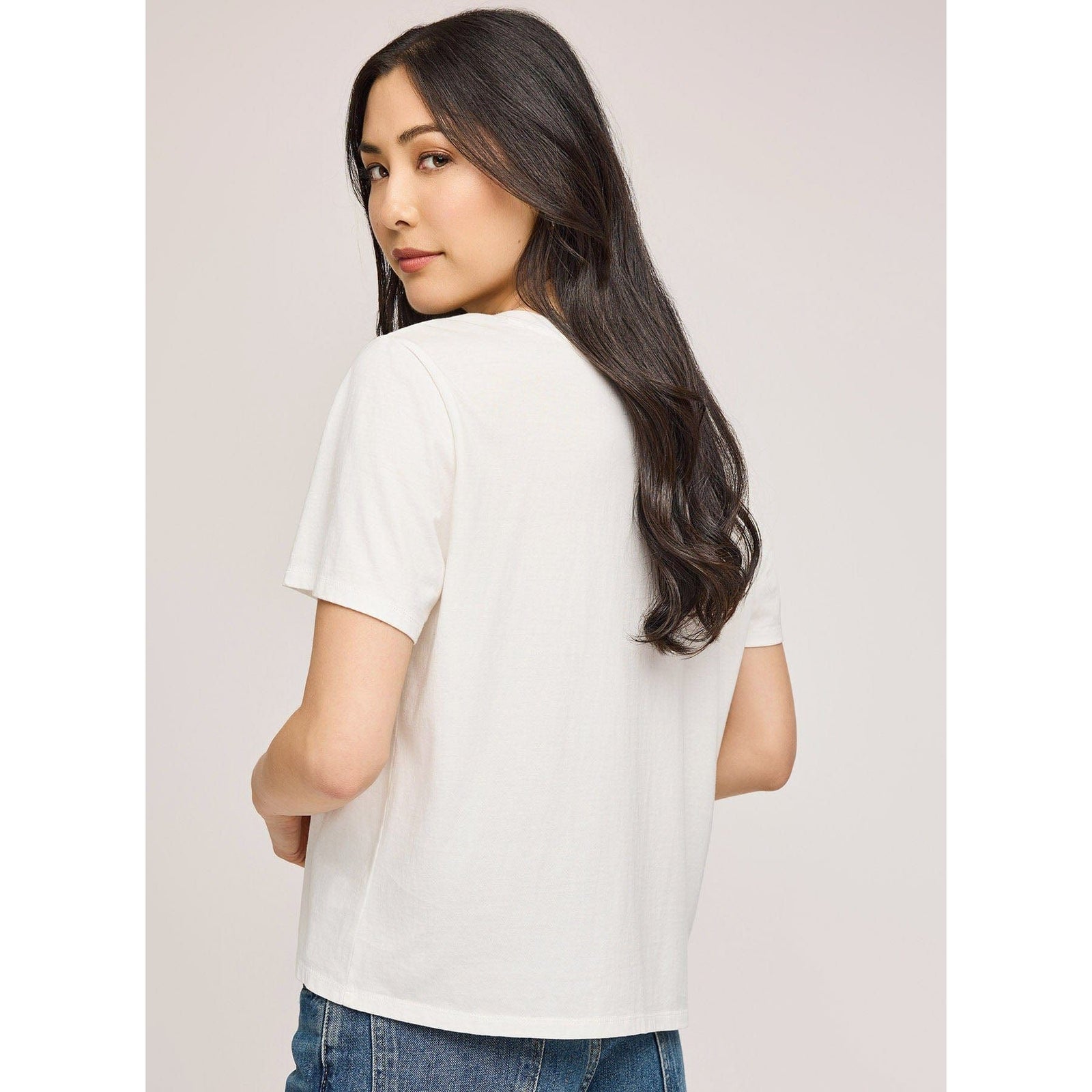 Model wearing white Gentle Fawn Lucy Top cropped shirt, short sleeves, back view