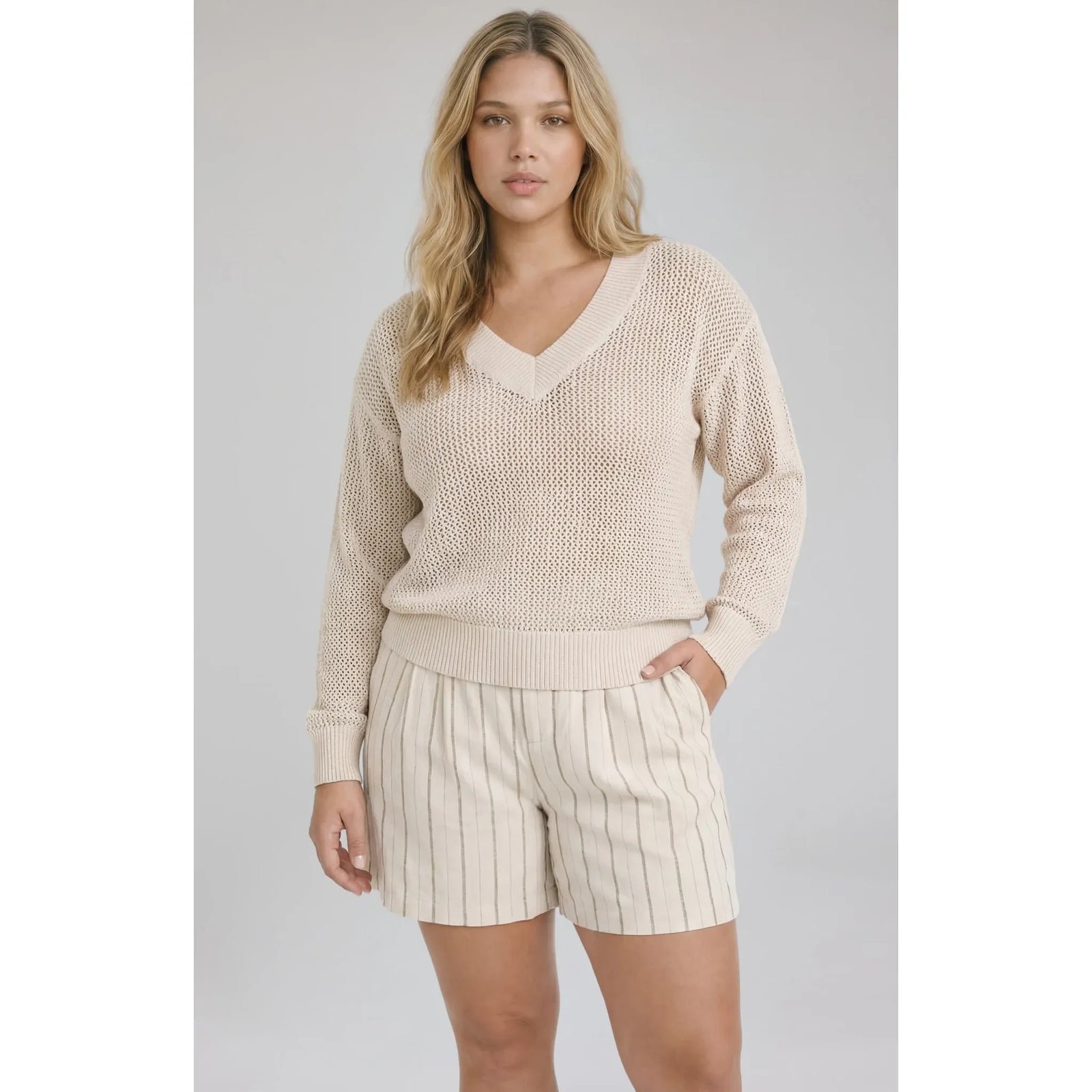 Beige Jensen V-Neck Pullover with open-knit texture and relaxed fit on model.