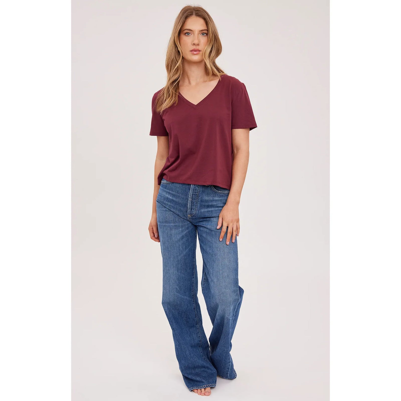 Maroon cotton V-neck cropped top paired with blue jeans for a casual everyday look.