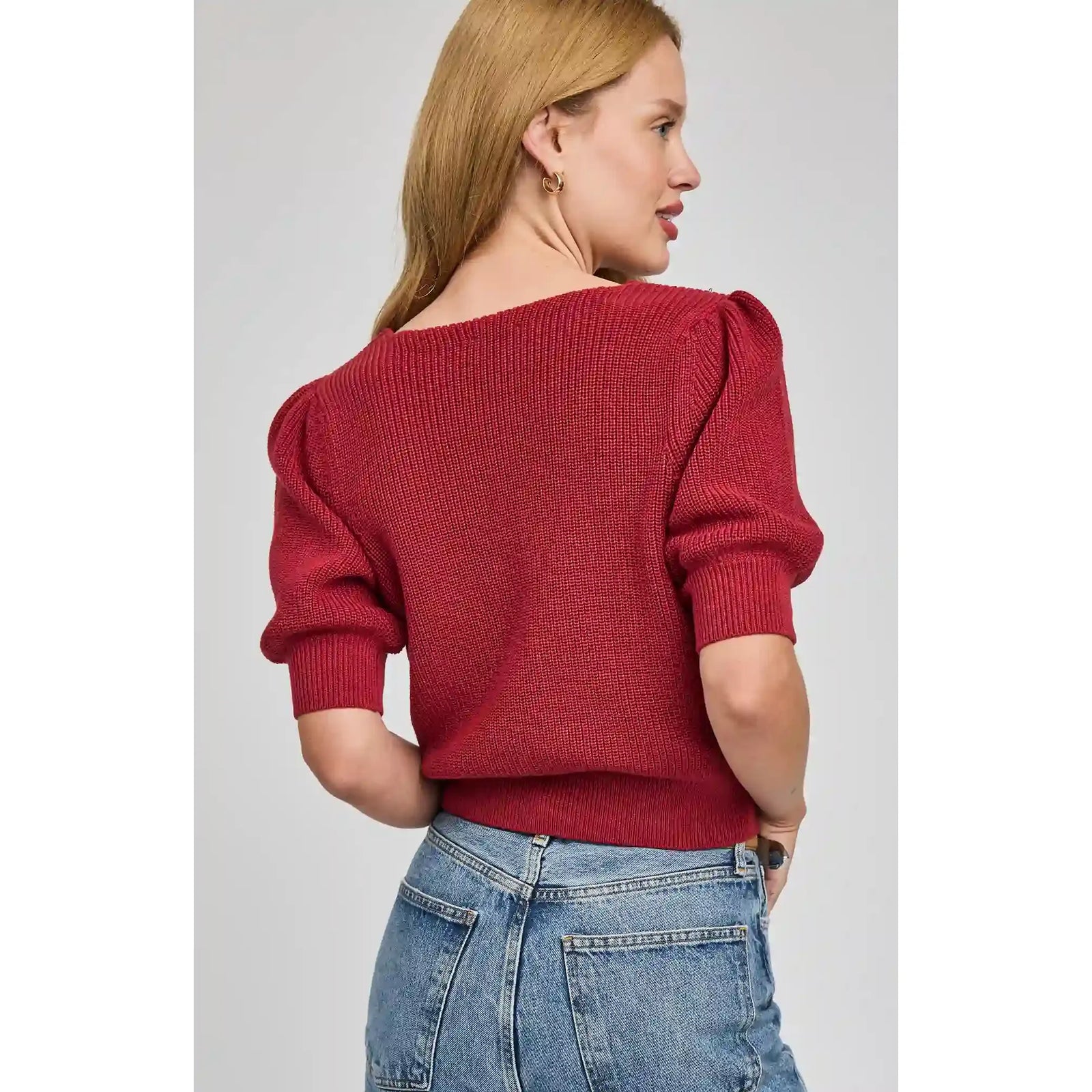 Gentle Fawn Phoebe V-Neck Sweater in red knit, back view with puff sleeves and jeans