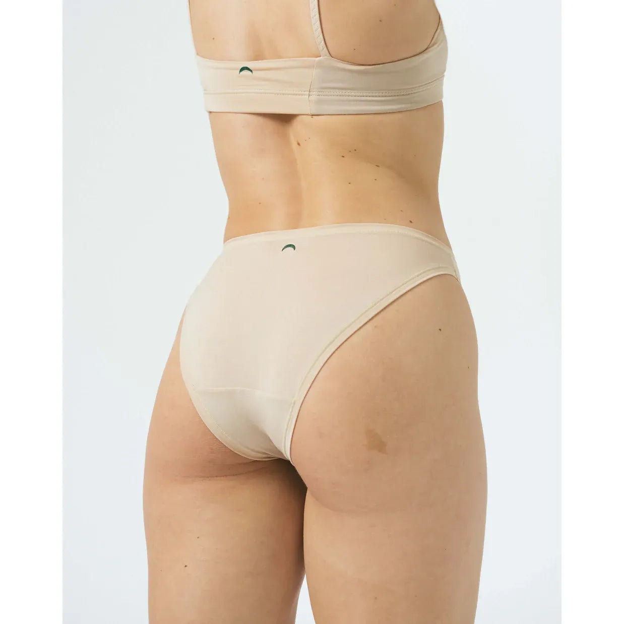 Back view of beige Huha Tata Mineral Bralette with elastic straps and broad underband, paired with a matching brief.