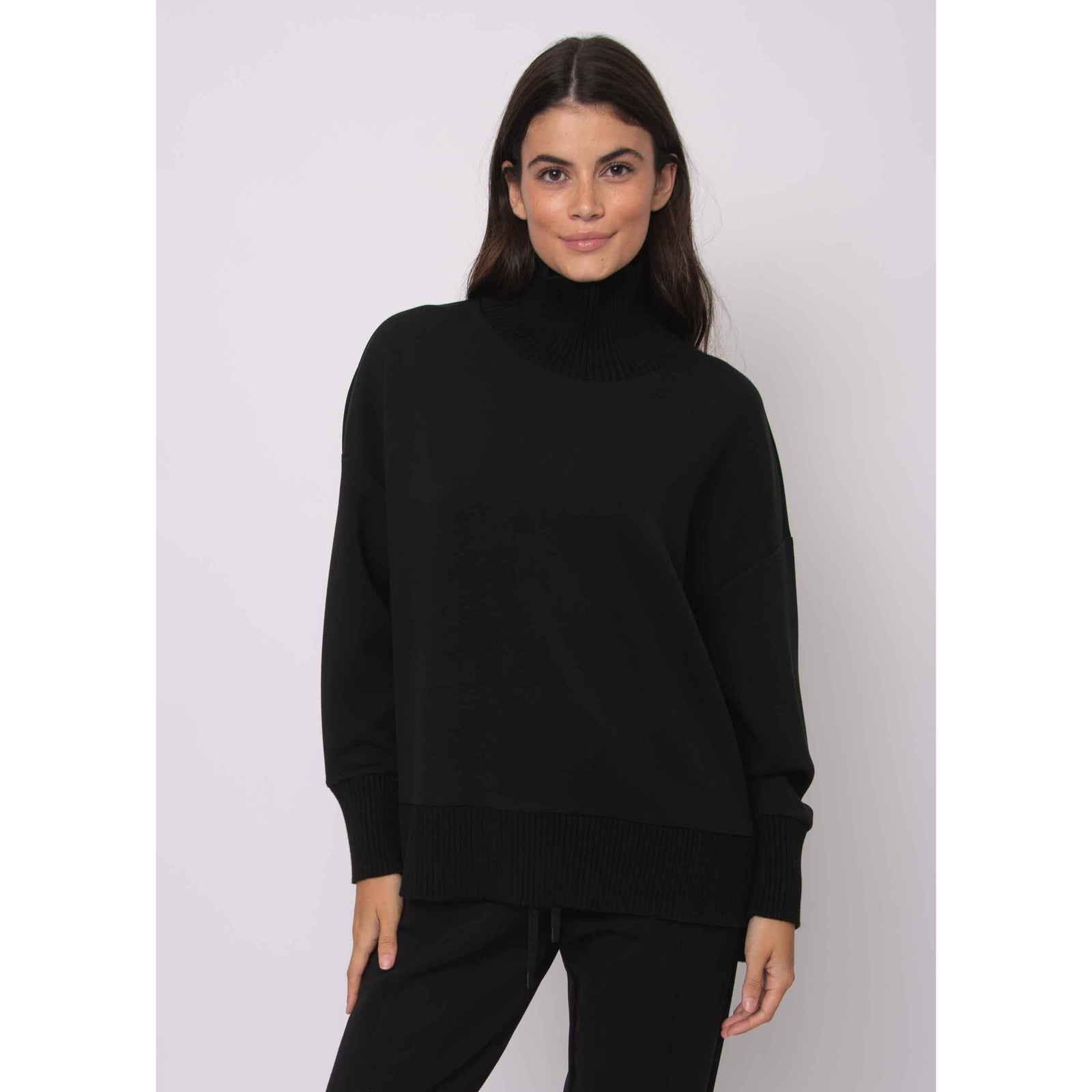Katelyn Soft Knit Sweater in black, oversized modal knit with ribbed cowl neck and side zipper detail.