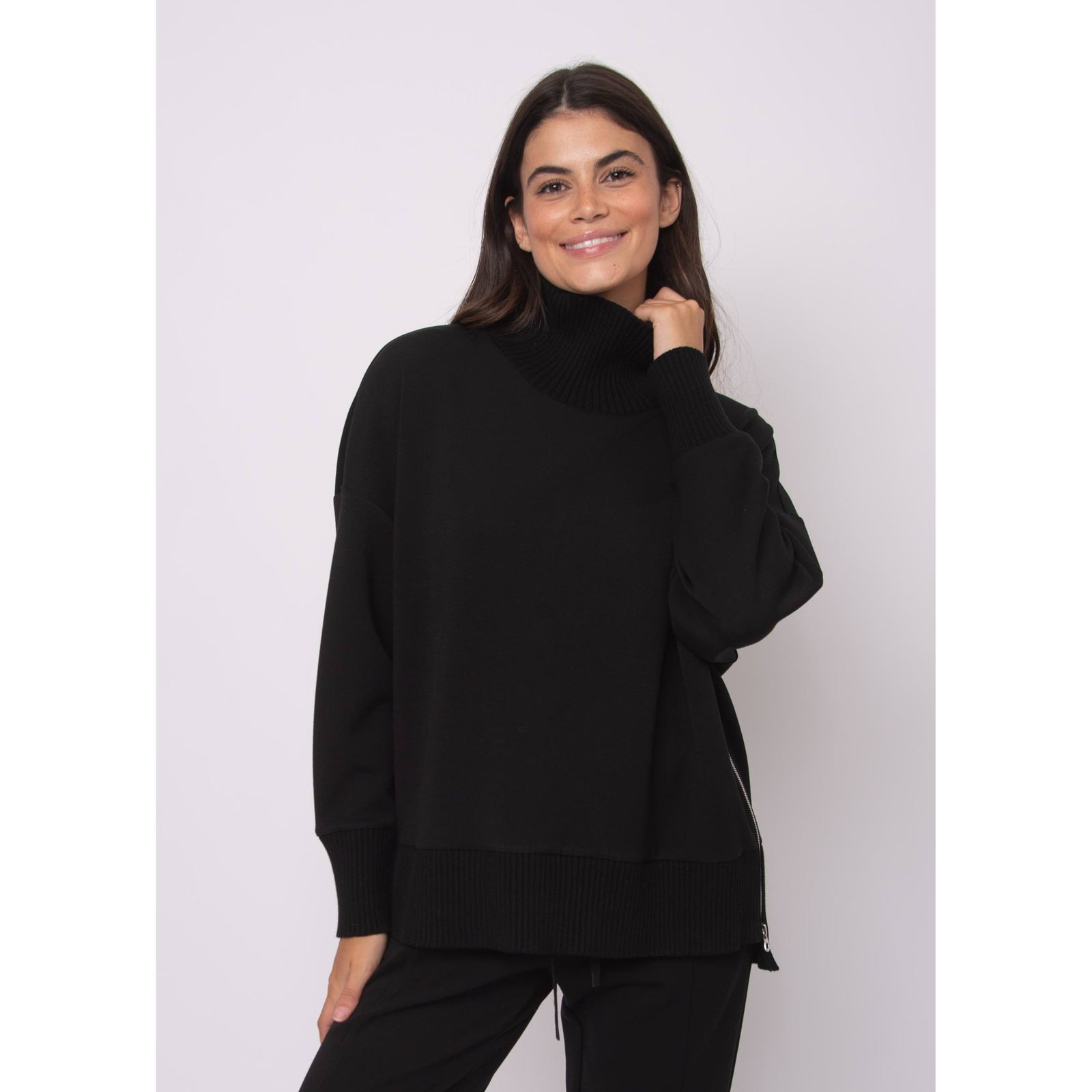 Katelyn Soft Knit Sweater in black, oversized modal knit with ribbed cowl neck, ribbed hem, and side zipper.