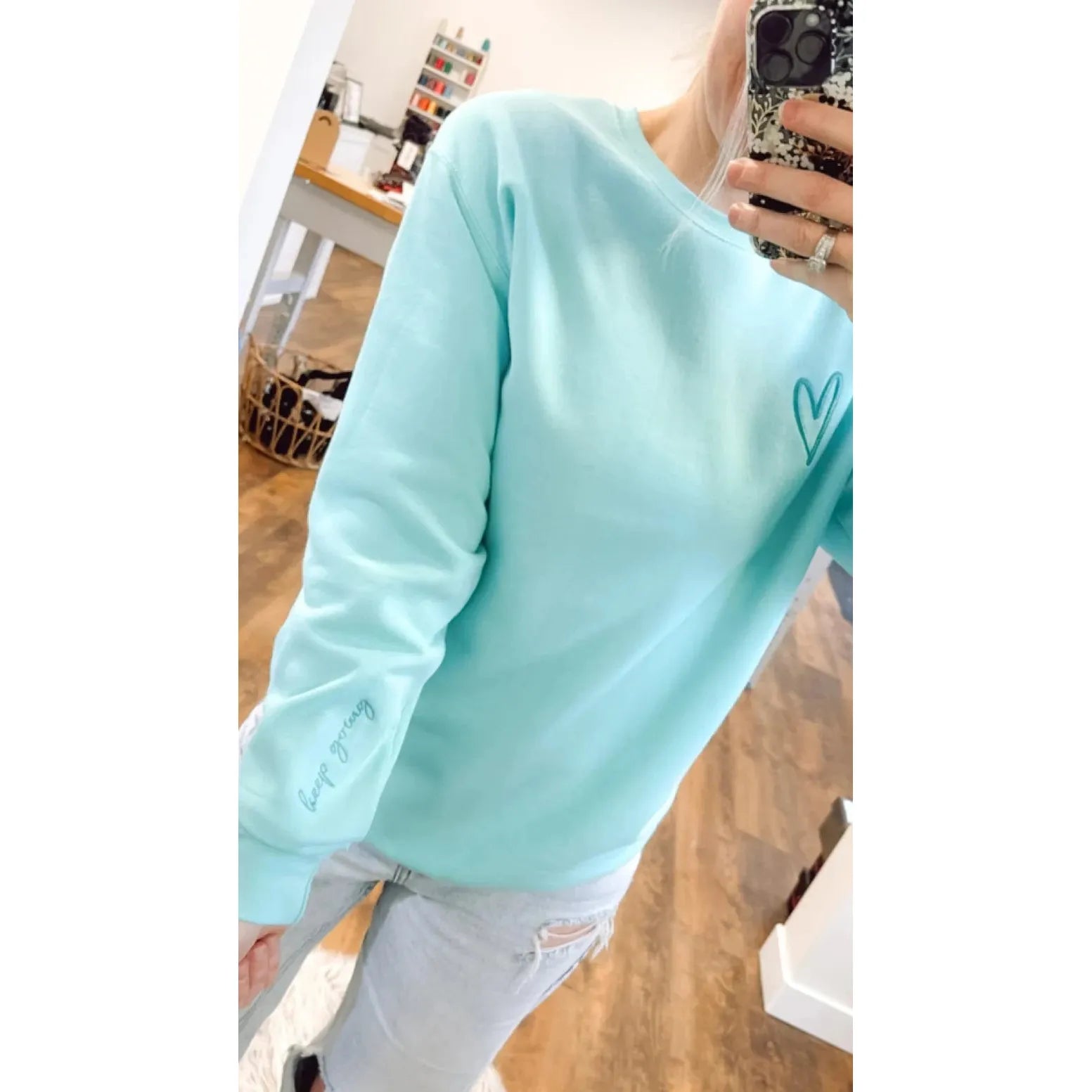 Soft mint Keep Going Embroidered Crew with heart detail and inspiring script to keep you motivated in style.