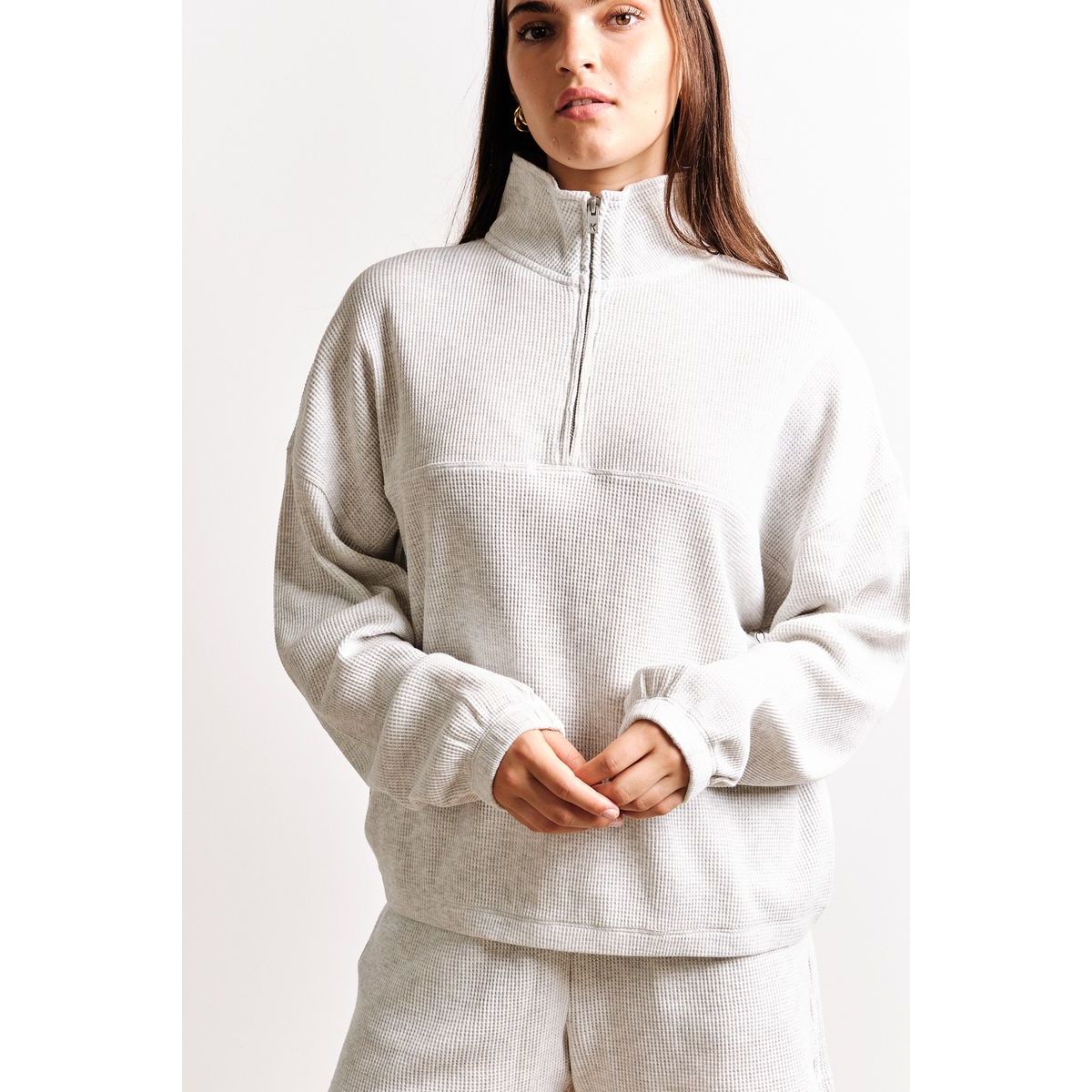 Kuwalla Bailey Waffle Zip Up in light grey waffle knit, half-zip neckline, oversized cozy layering top.