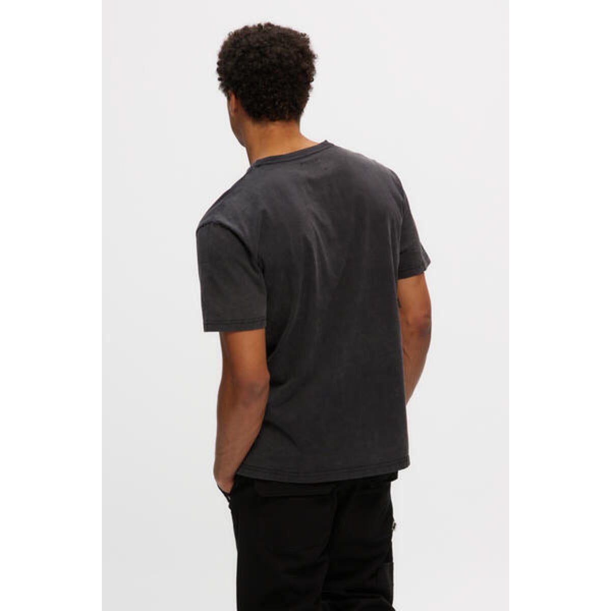 Kuwalla Heavyweight Boss Tee on a model in black oversized tee with vintage wash and relaxed fit.