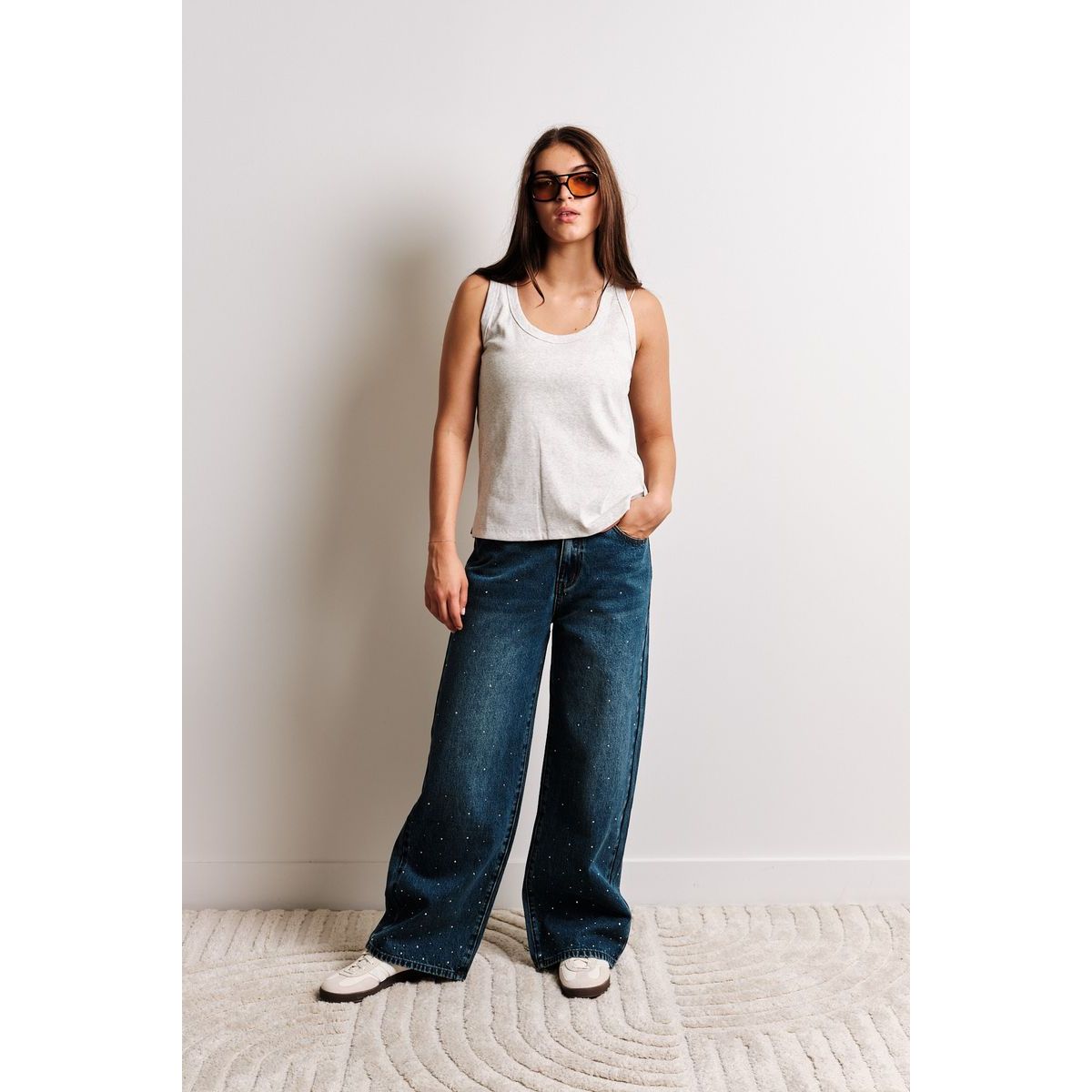 Kuwalla Lia Relaxed Tank worn by a model in light gray sleeveless top, relaxed-fit, ideal for summer layering.