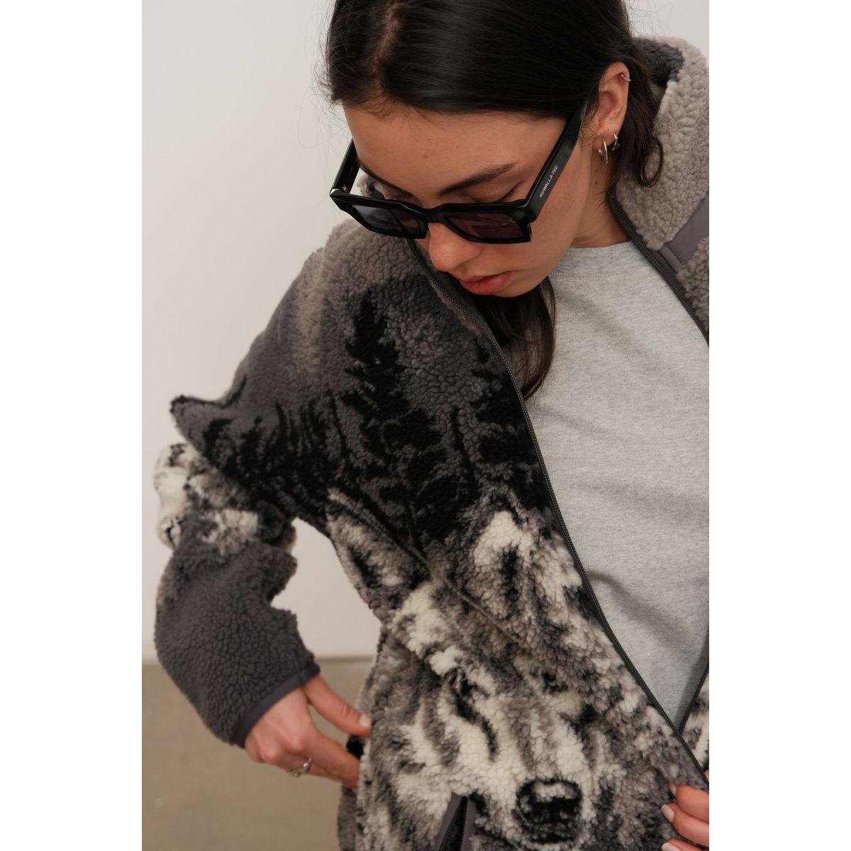 Kuwalla Printed Sherpa Fleece Jacket Wolf Pack on a model, plush fleece with wolf print and zip pockets.