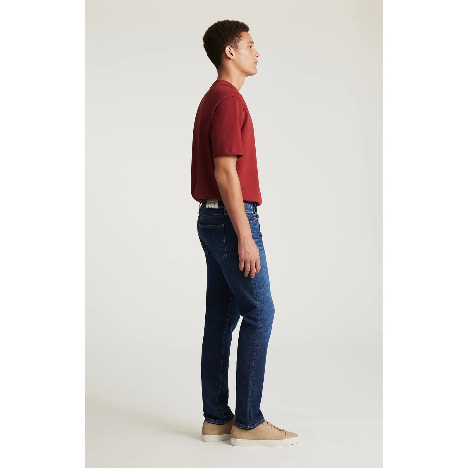 Mavi Jake Rinse Dark Brushed Classic Vintage jeans on model with red tee, slim through hip, thigh, and leg opening.