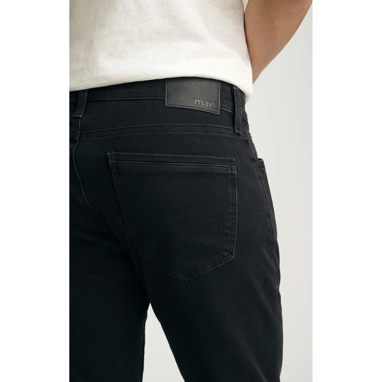 Mavi Jake Smoke Explorer Denim jeans in washed-out black, back view with leather logo patch on waistband.
