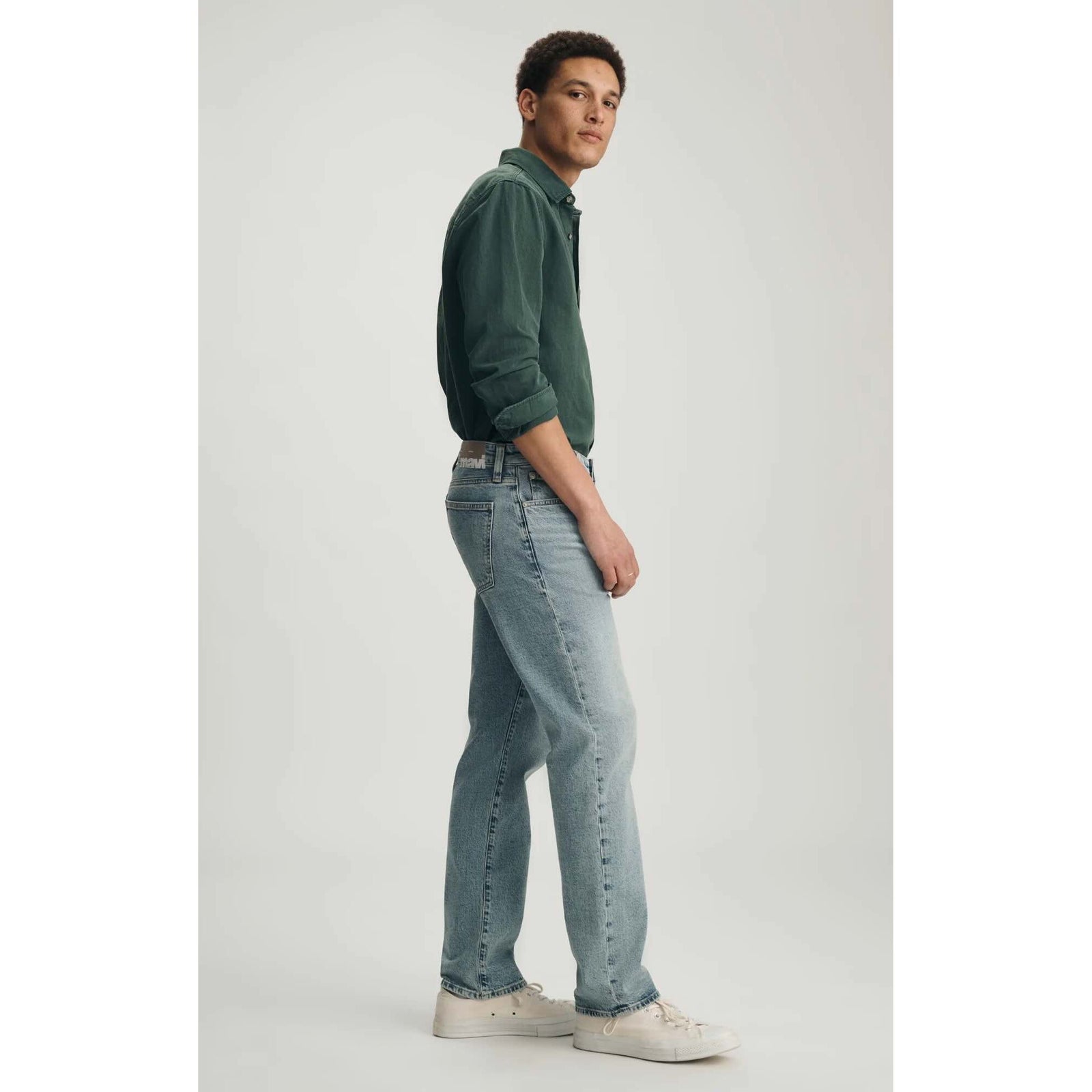 Male model wearing Mavi Zach Lt Shaded Classic Blue Denim jeans, straight-leg, light-wash.