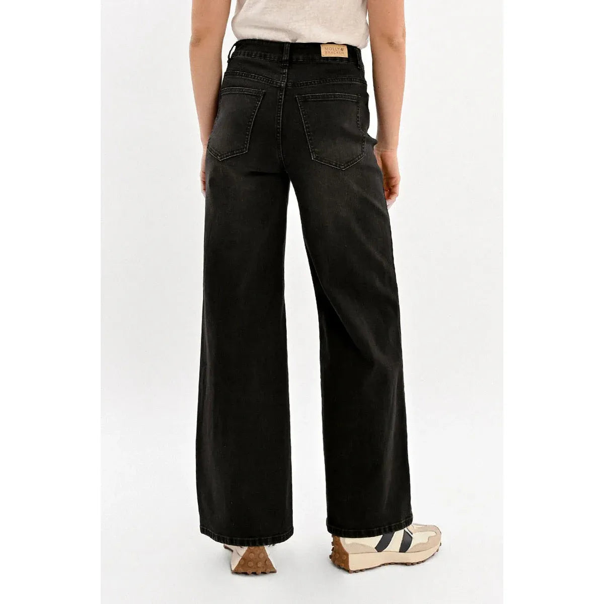 Back view of Molly Bracken Jamie wide-leg black denim pants with rear pockets and brand tag.
