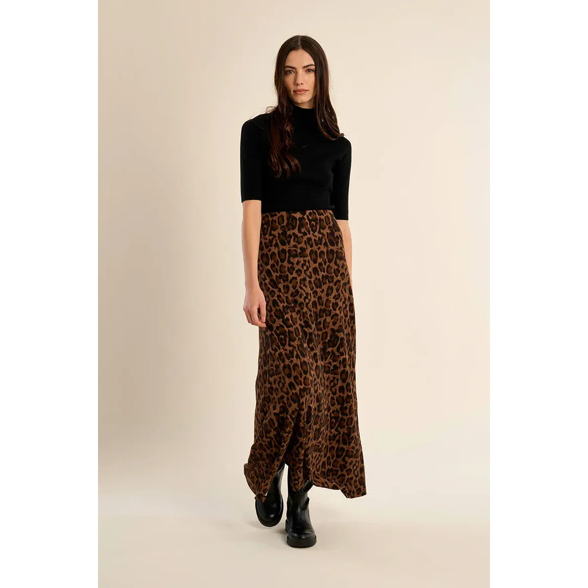 High-waisted leopard print maxi skirt with elastic waistband and straight fit, styled with black boots.