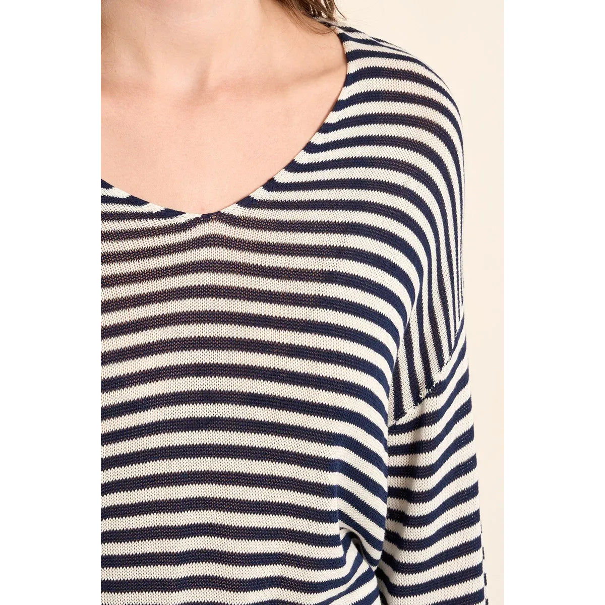 Navy and white striped knit sailor shirt with a relaxed oversized silhouette and V-neck.