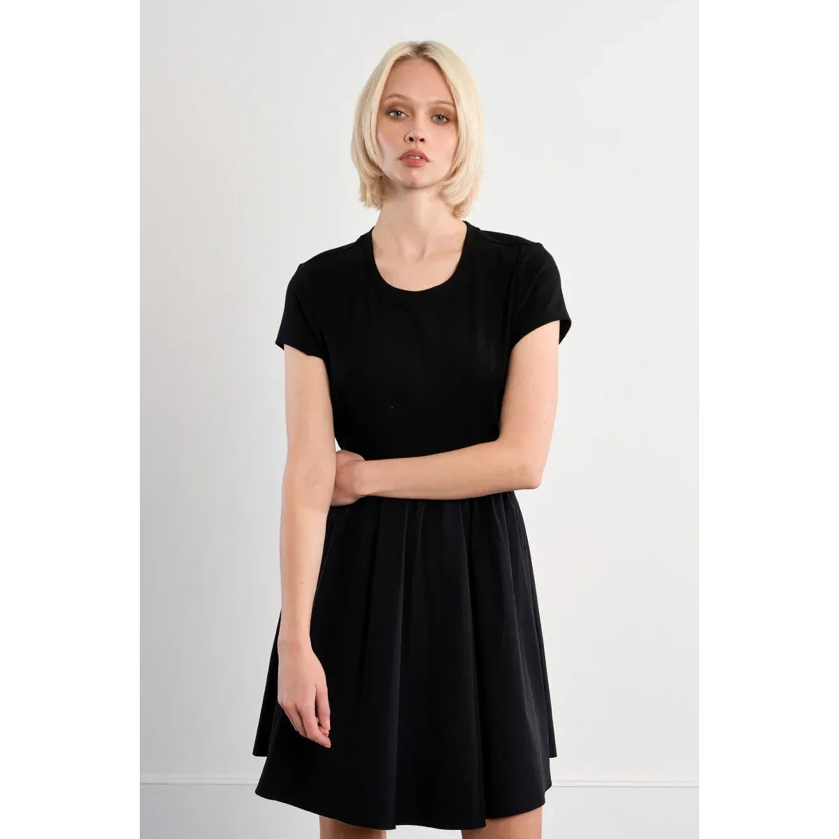 Black Molly Bracken nylon drawstring mini dress with boat neck and short sleeves on a model.