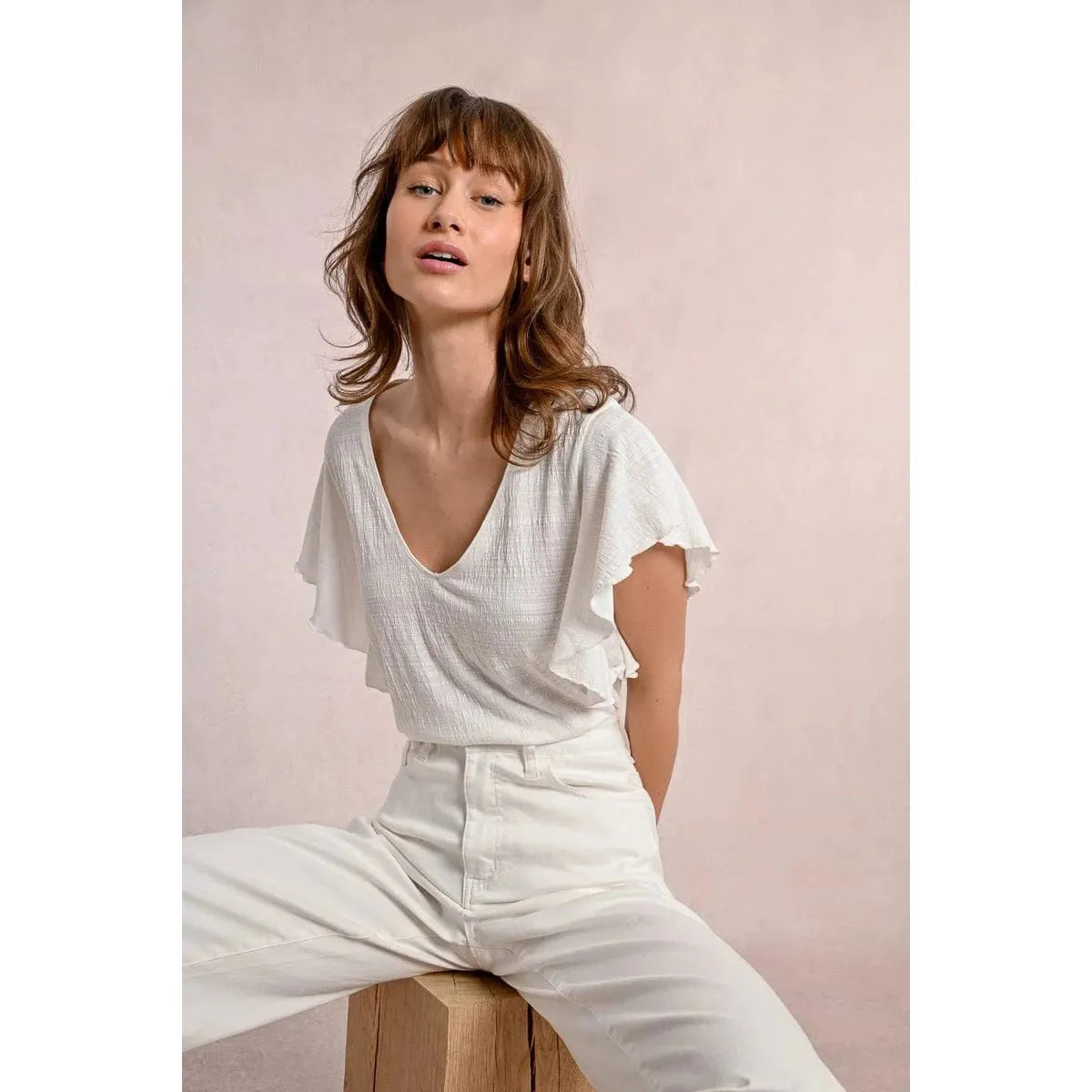 Stylish Molly Bracken Ruffled Tshirt in off-white, featuring a V neckline and playful ruffled sleeves for a chic look.