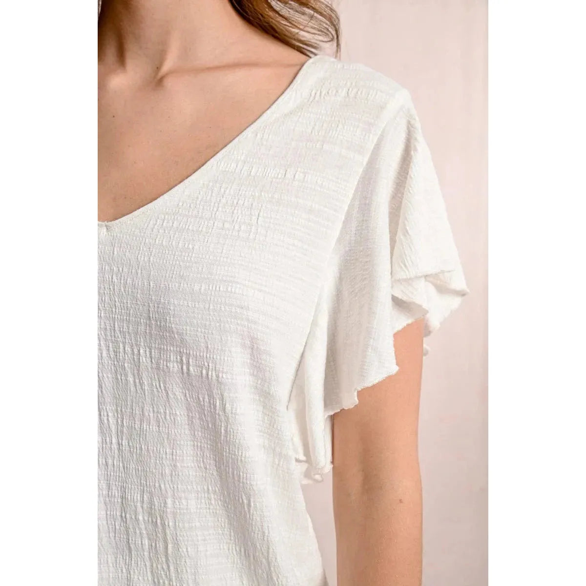 Elevate your style with the Molly Bracken Ruffled Tshirt, featuring a wide V neckline and playful ruffled sleeves.