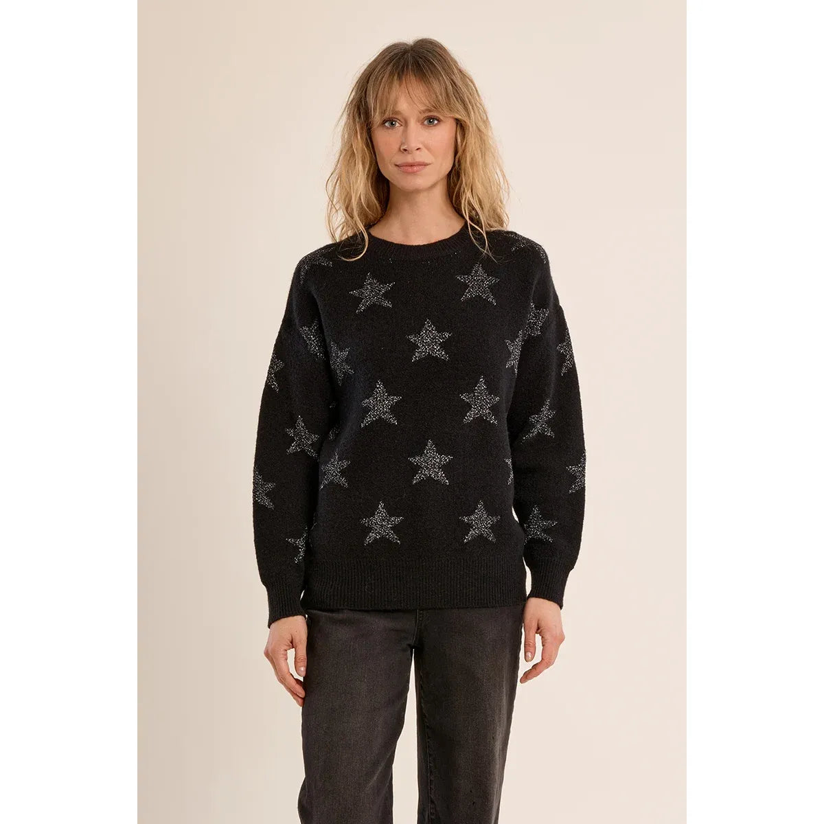Black knit sweater with iridescent star pattern, round neckline, long sleeves, ribbed trim, and relaxed straight fit.