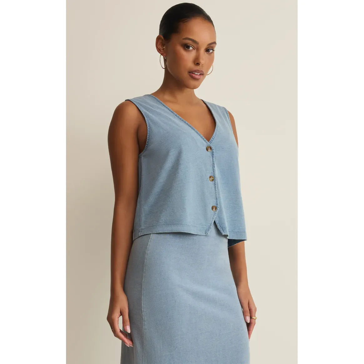 Z Supply Noelle Jersey Denim Tank on model, light denim sleeveless top with V-neck and button front.