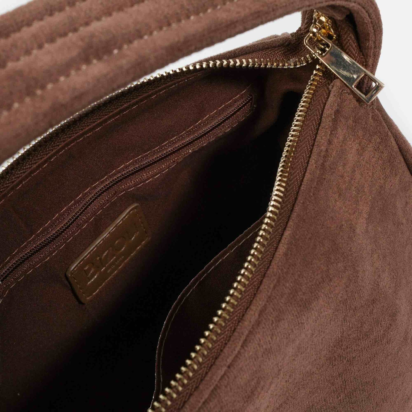 Pale brown suede handbag with gold-tone hardware, zip closure, and compact organized interior.