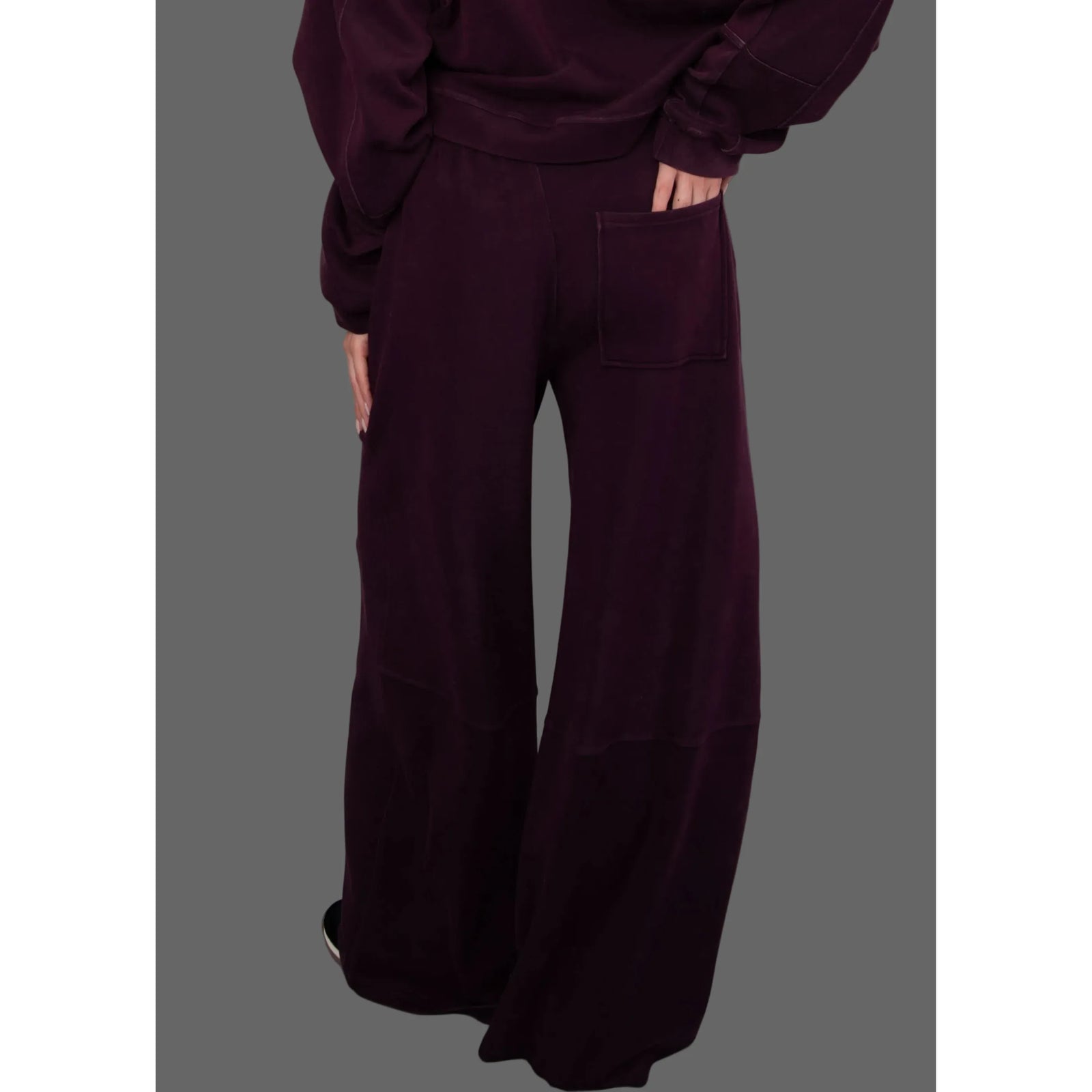 Back view of burgundy wide-leg soft knit pull-on pants featuring a rear patch pocket and relaxed, fluid fit.