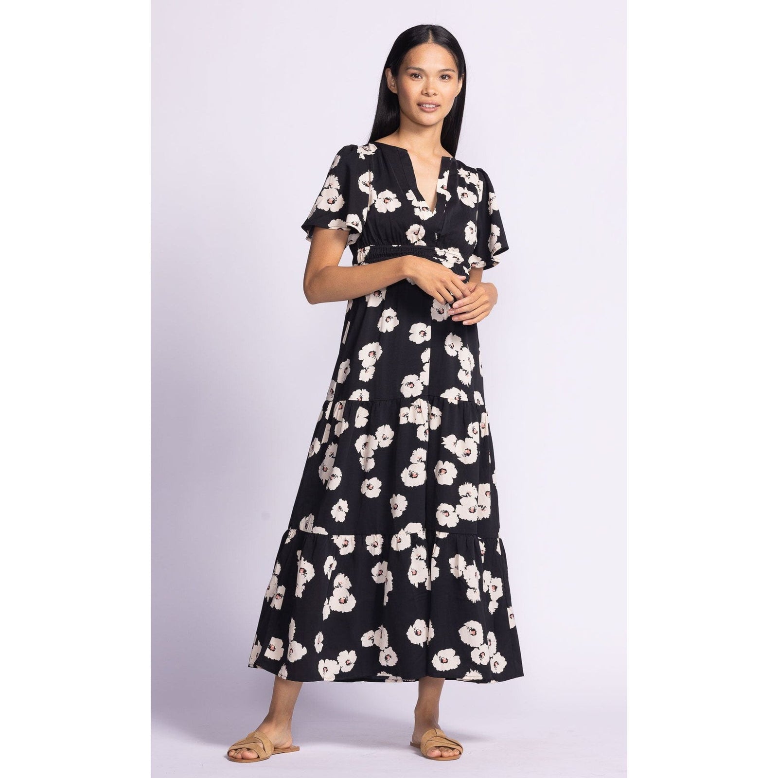 Stylish woman wearing the Pink Martini Margaret Dress with puffed sleeves and floral print, perfect for any occasion.