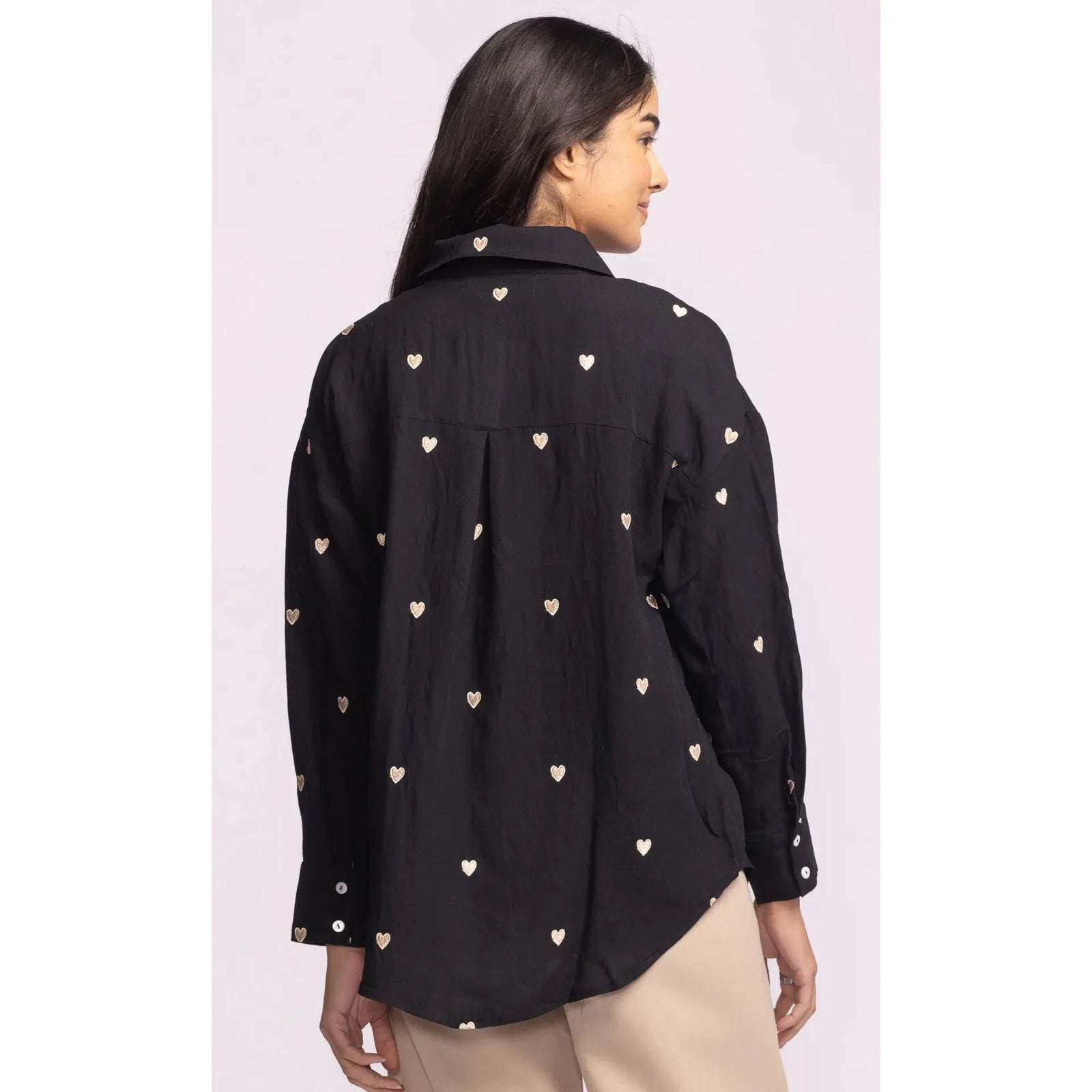 Pink Martini Spezia Topp black top with delicate embroidered hearts, classic collar, V-neck, cuffed sleeves; back view.