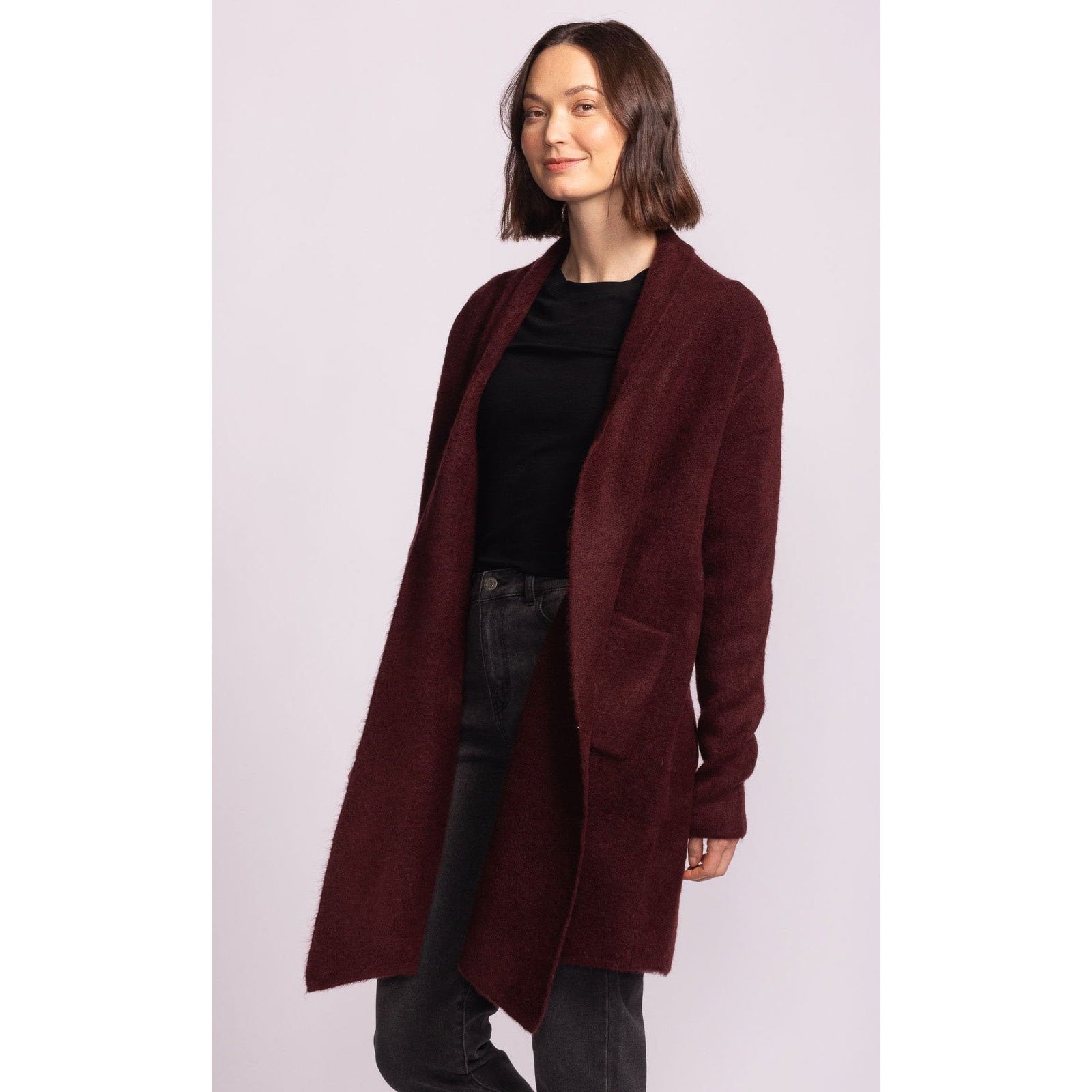 Pink Martini Stockport Jacket in aubergine worn by model; mid-length burgundy coat with pockets.
