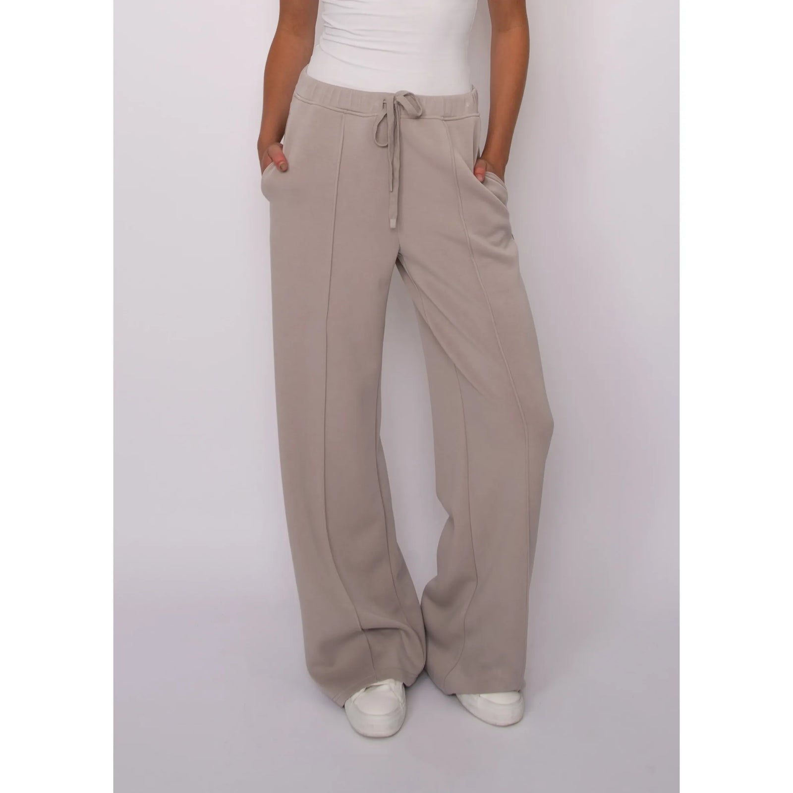 Beige soft knit wide-leg pants with adjustable drawstring waist and side pockets for effortless comfort and style.