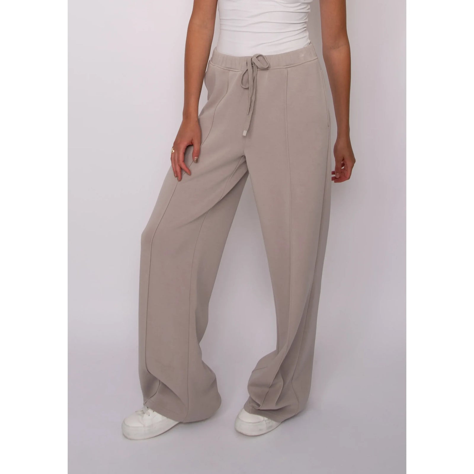 Beige soft knit pull-on drawstring pants with wide legs and adjustable waist for comfortable, effortless style.