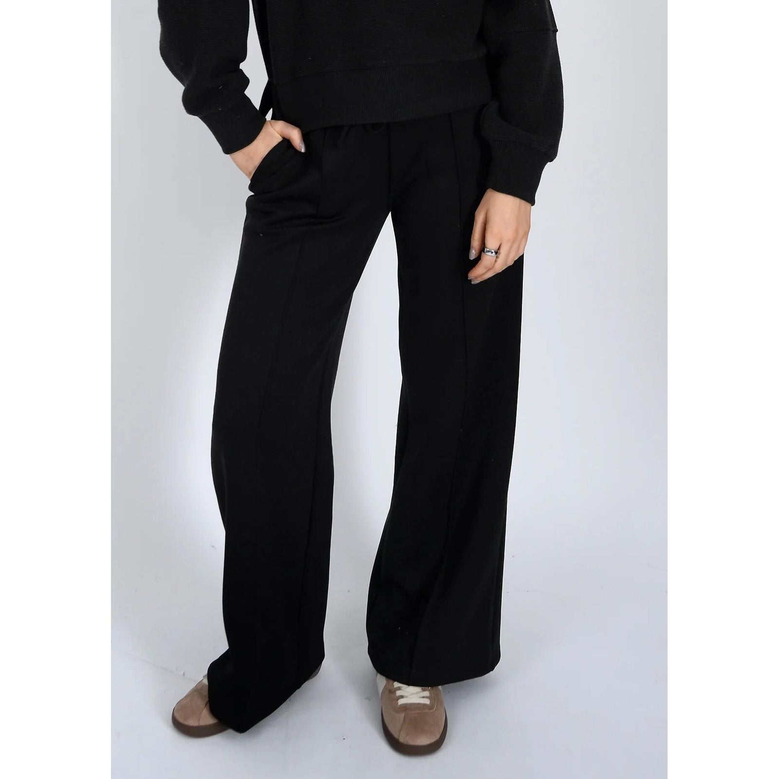Black soft knit wide-leg pants with adjustable drawstring waist, featuring side pockets and a relaxed, comfortable fit.