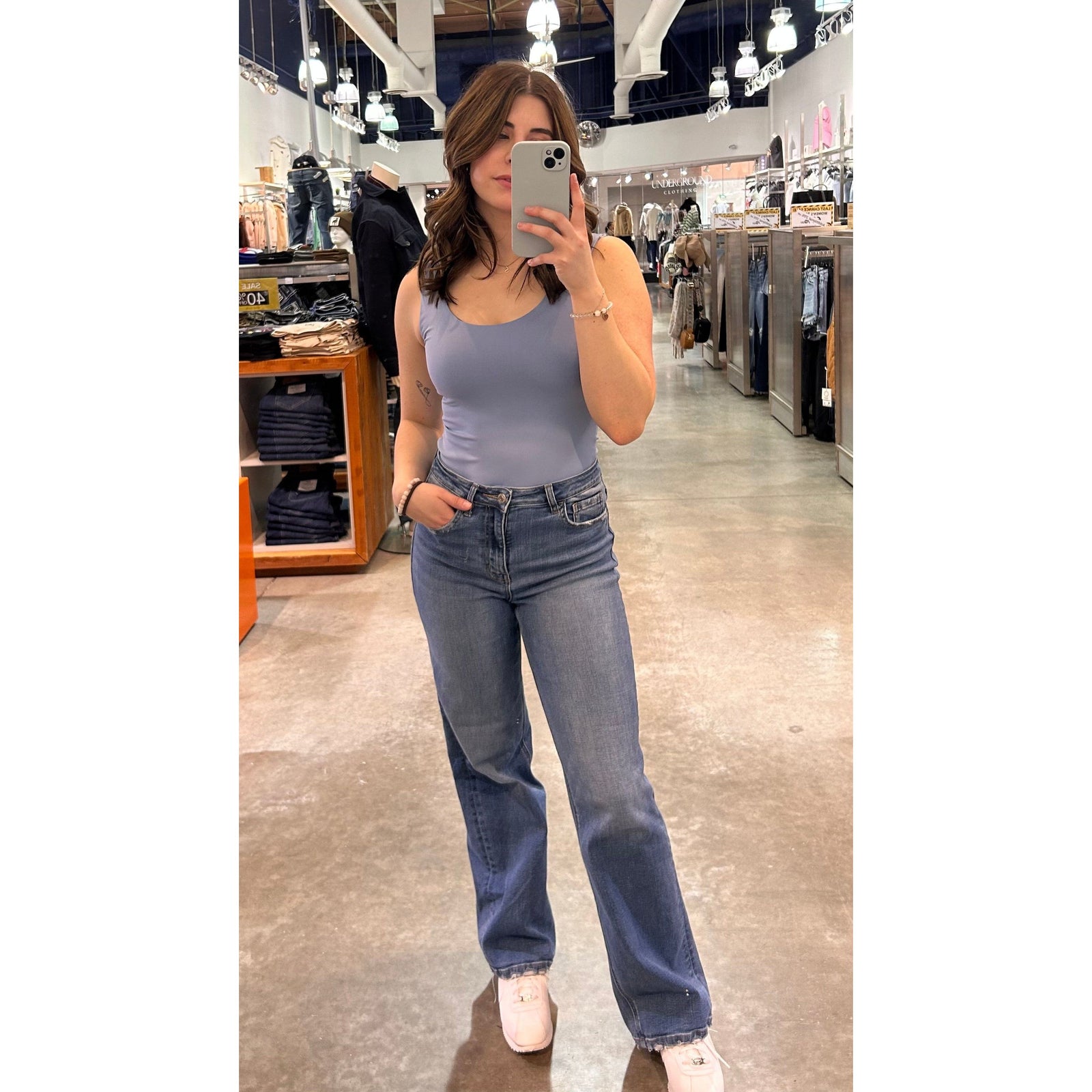 Woman wearing Second Skin Tanith Double Uneck Tank Top in light blue, store mirror selfie.