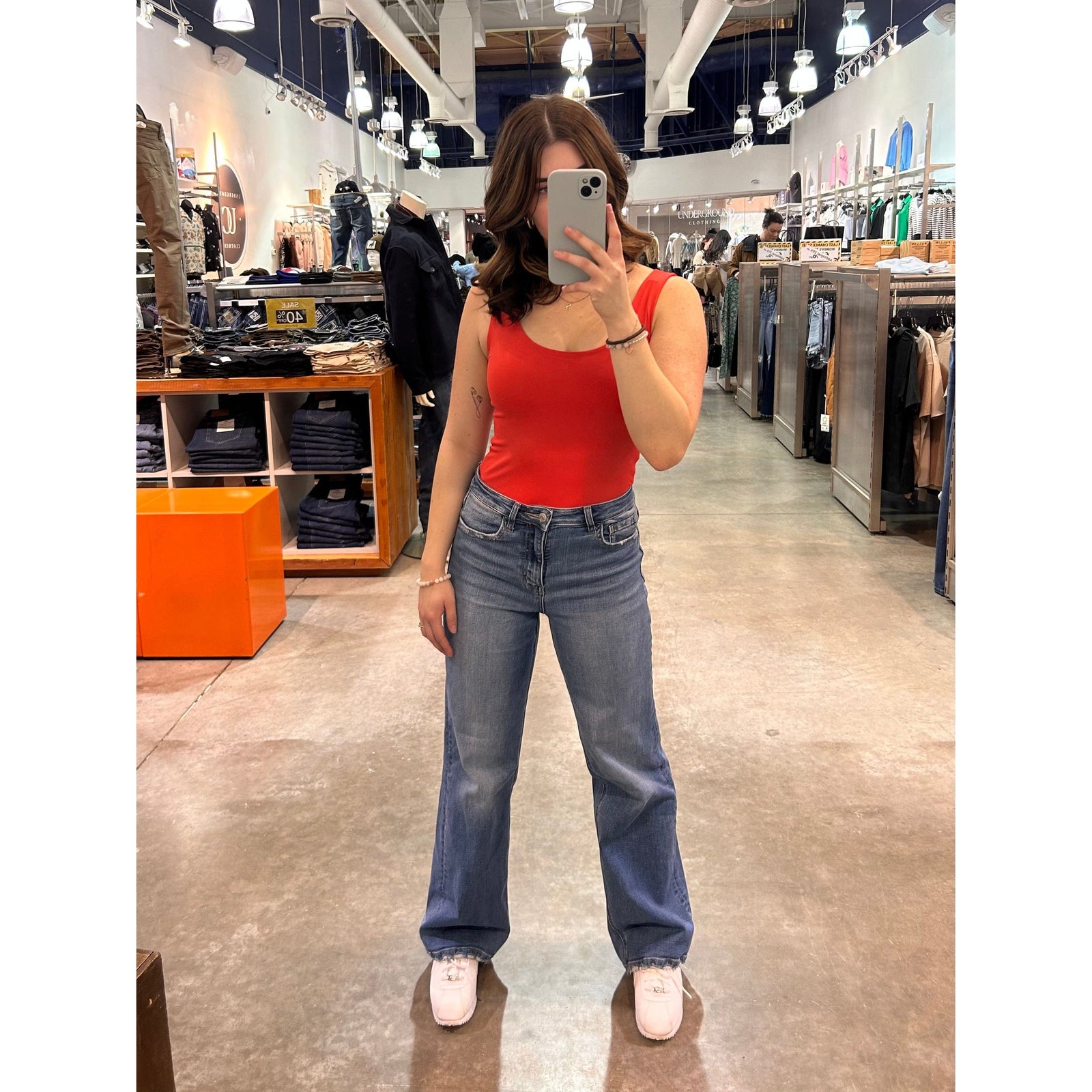 Woman in store wearing Second Skin Tanith Double Uneck Tank Top, red sleeveless top.