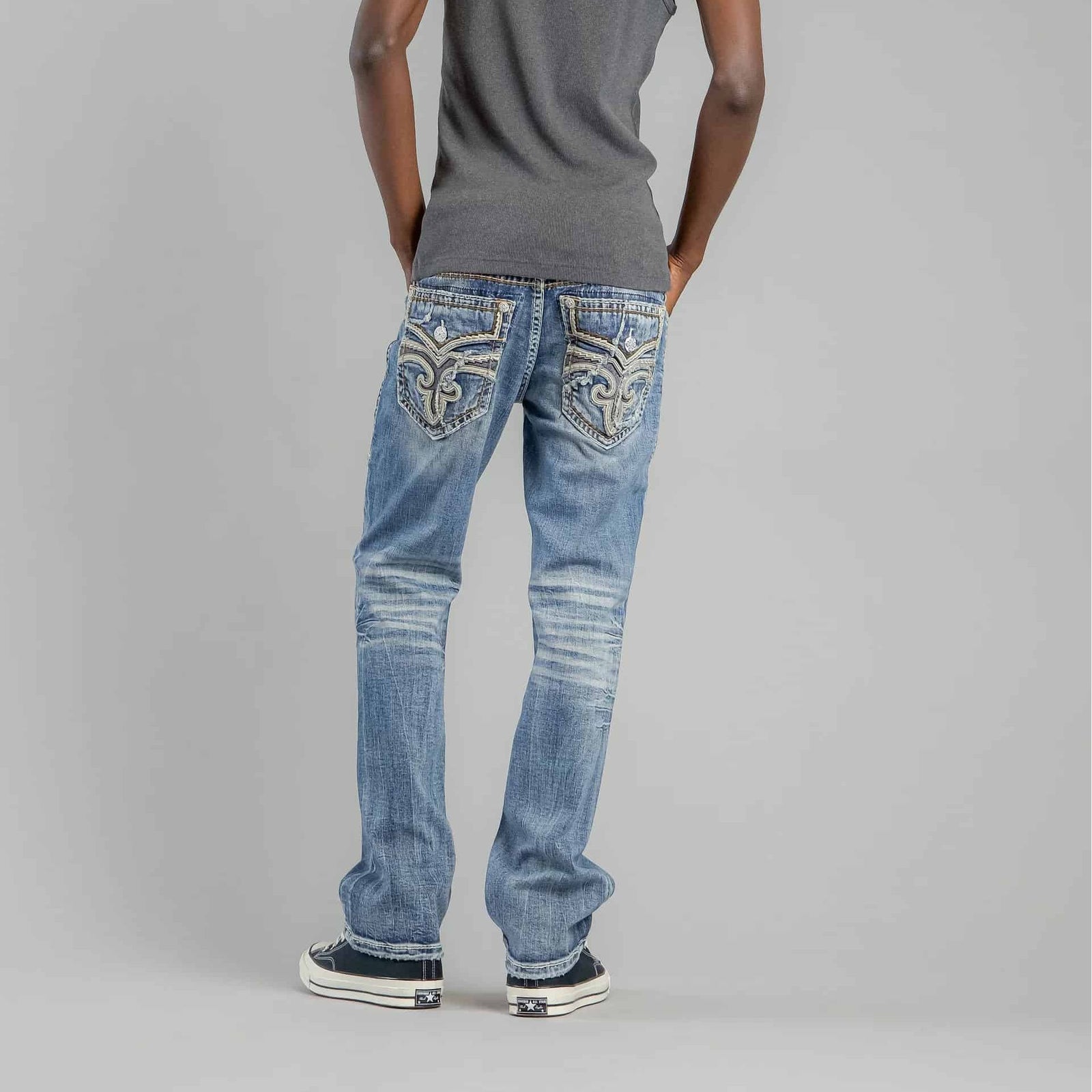 Rock Revival Andrew B200 Bootcut jeans on model, back view with ornate embroidered pockets in medium blue wash.
