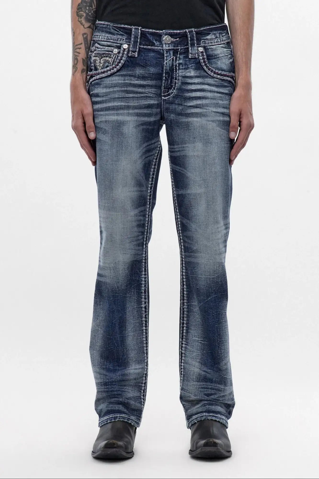 Men's medium blue wash bootcut jeans with signature front pocket embroidery and distressed detailing.