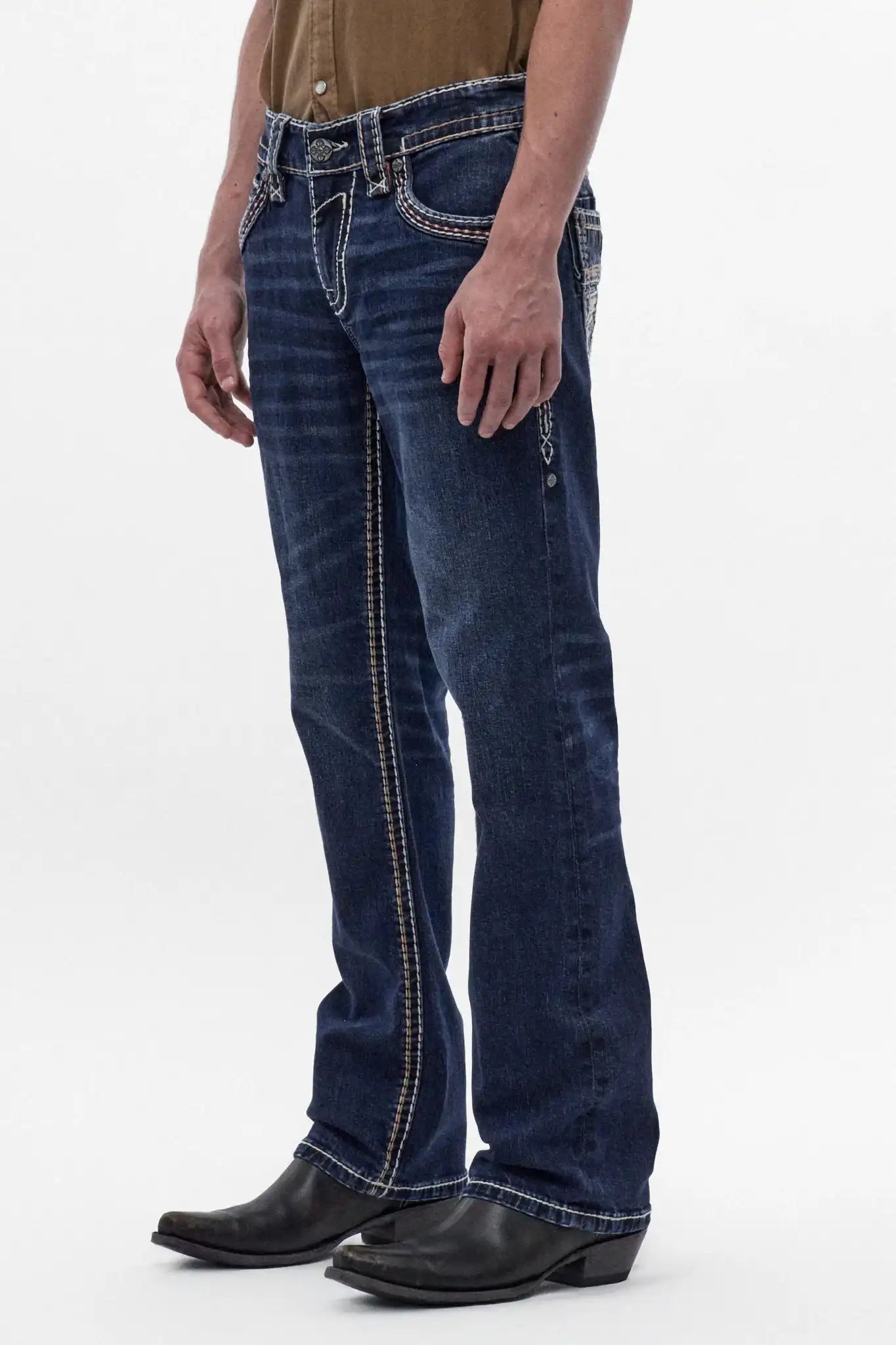 Men's dark blue bootcut jeans featuring contrast stitching and a polished wash, styled with black cowboy boots.