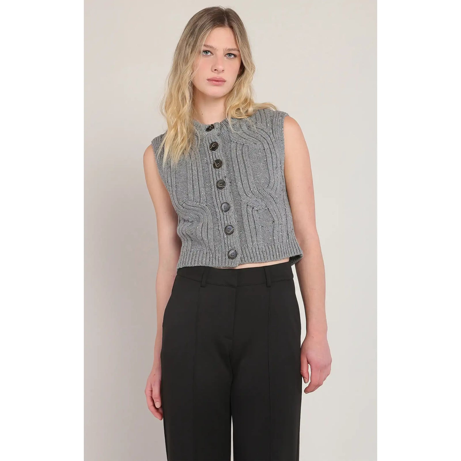 Room 34 gray button-front cable-knit sweater vest, cropped, styled over black high-waisted pants.