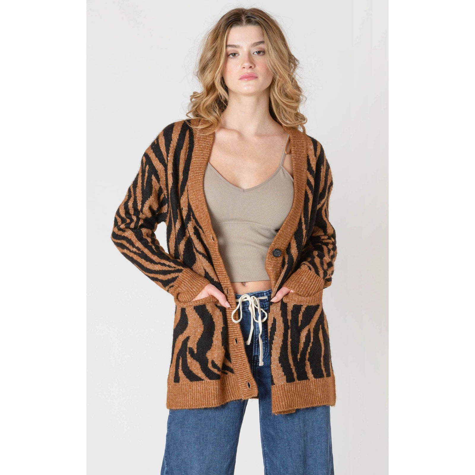 Room 34 Print Cardigan in tiger print, oversized knit worn open over a beige crop top.