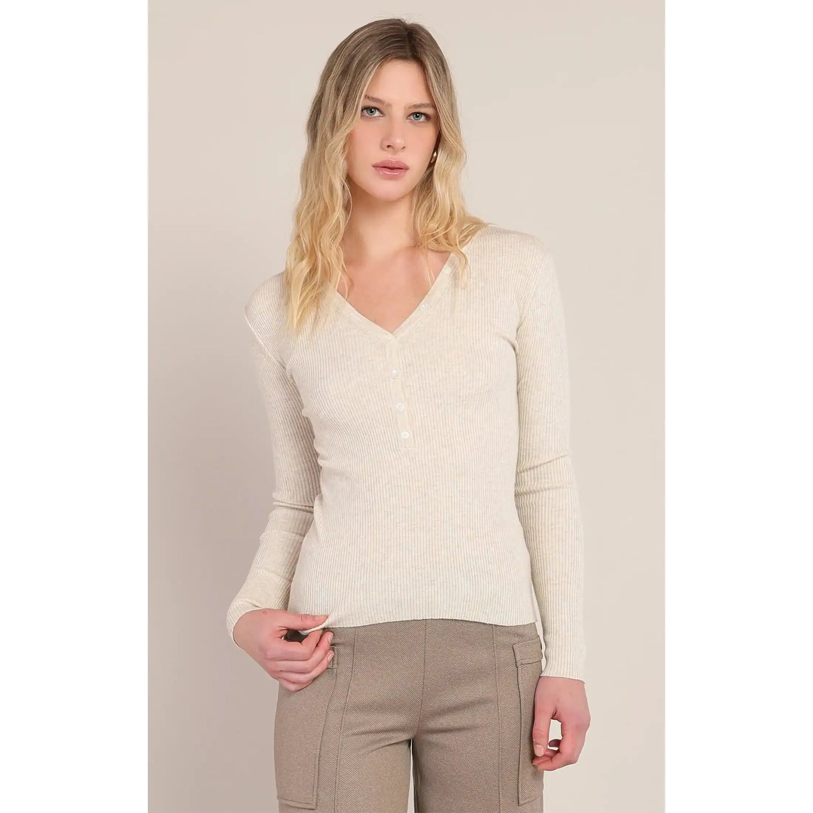 Cream ribbed V-neck sweater with button placket. Cozy polyester-acrylic blend knit top featuring vertical texture and long sleeves.