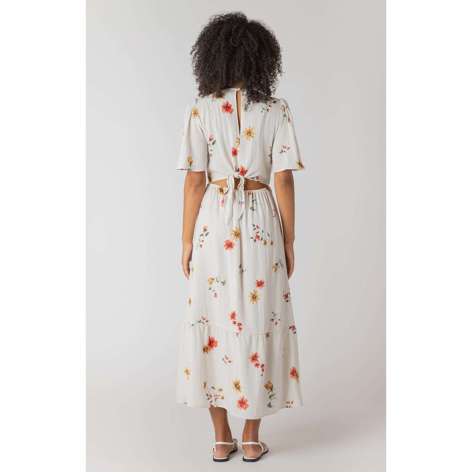 Ivory floral Room 34 maxi dress with short sleeves, back tie and cutout.