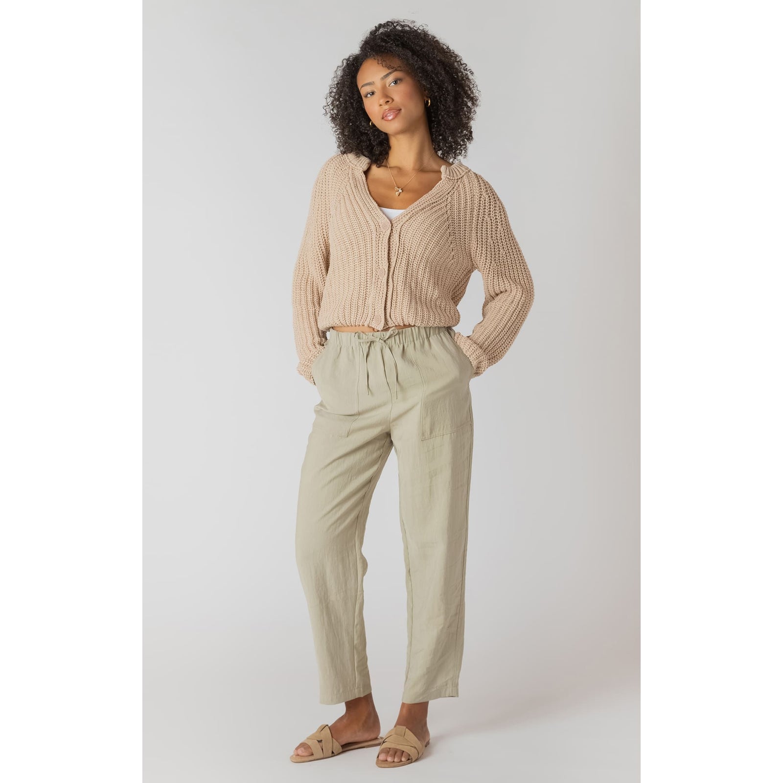 Room 34 Textured Button Front Cardigan, cropped beige knit with oversized buttons, styled with light khaki pants.