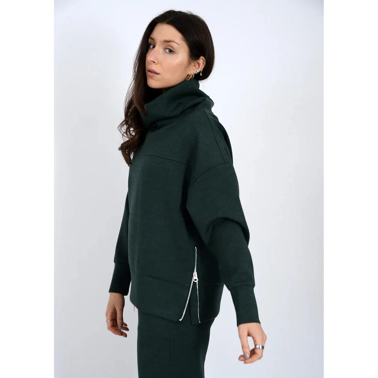 Fillana Soft Knit LS Foldover forest green pullover on model with foldover collar and zip side vents