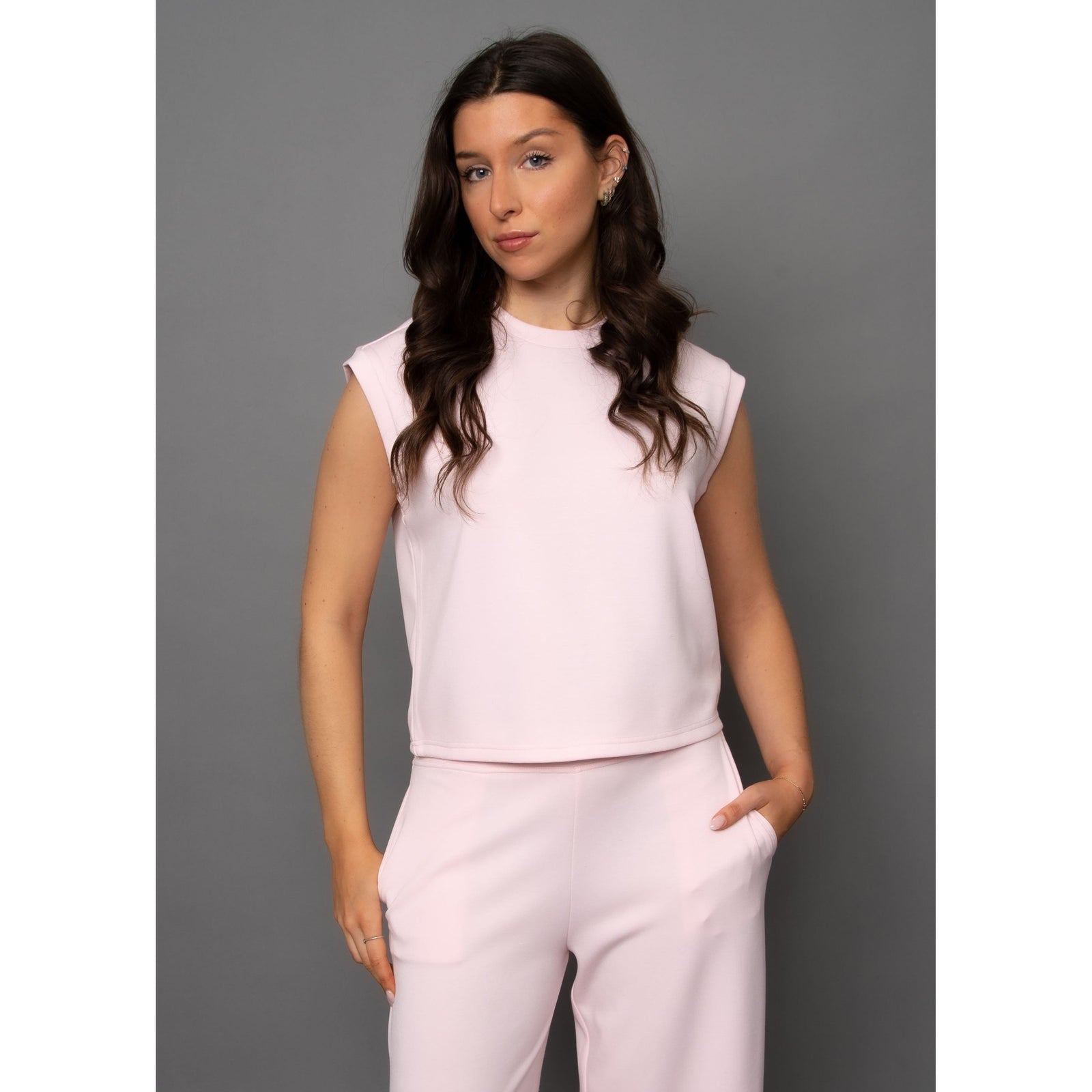 Stylish model wearing the Scuba Miva Soft Knit Tank Top in pink, perfect for comfort and pairing with shorts or pants.