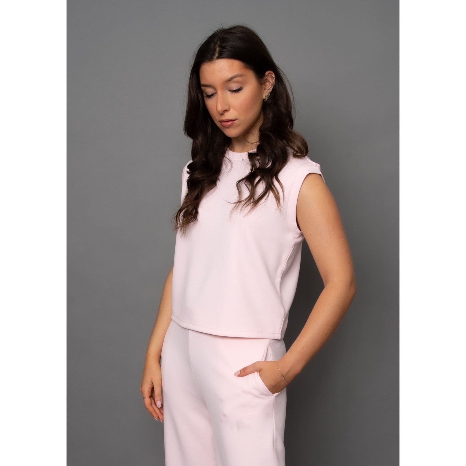 Stylish model wearing the Scuba Miva Soft Knit Tank Top in pink, showcasing its soft fabric and perfect fit.