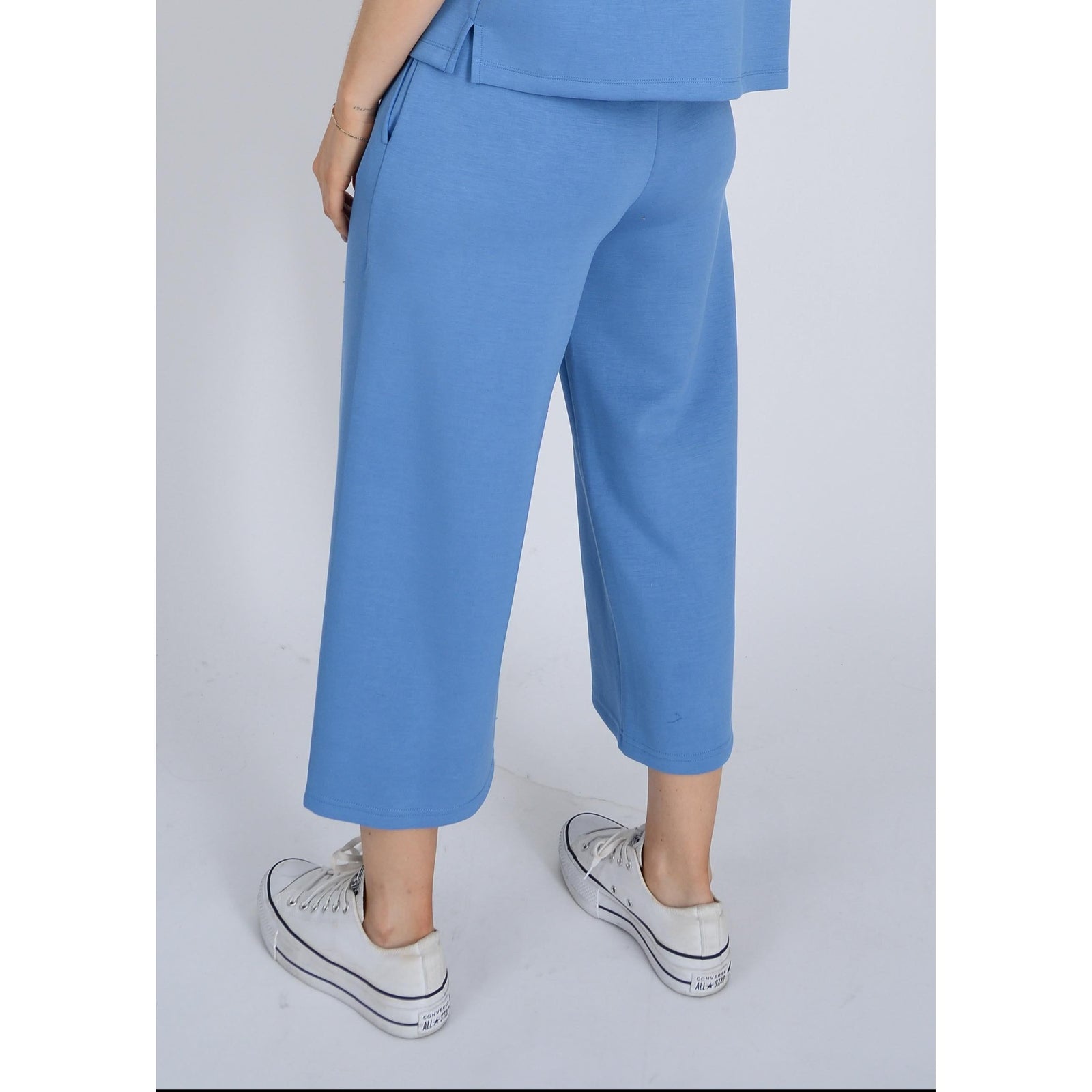 Elevate your style with Scuba Victoria Soft Knit Cropped Pants, featuring a wide leg and pockets for ultimate comfort.