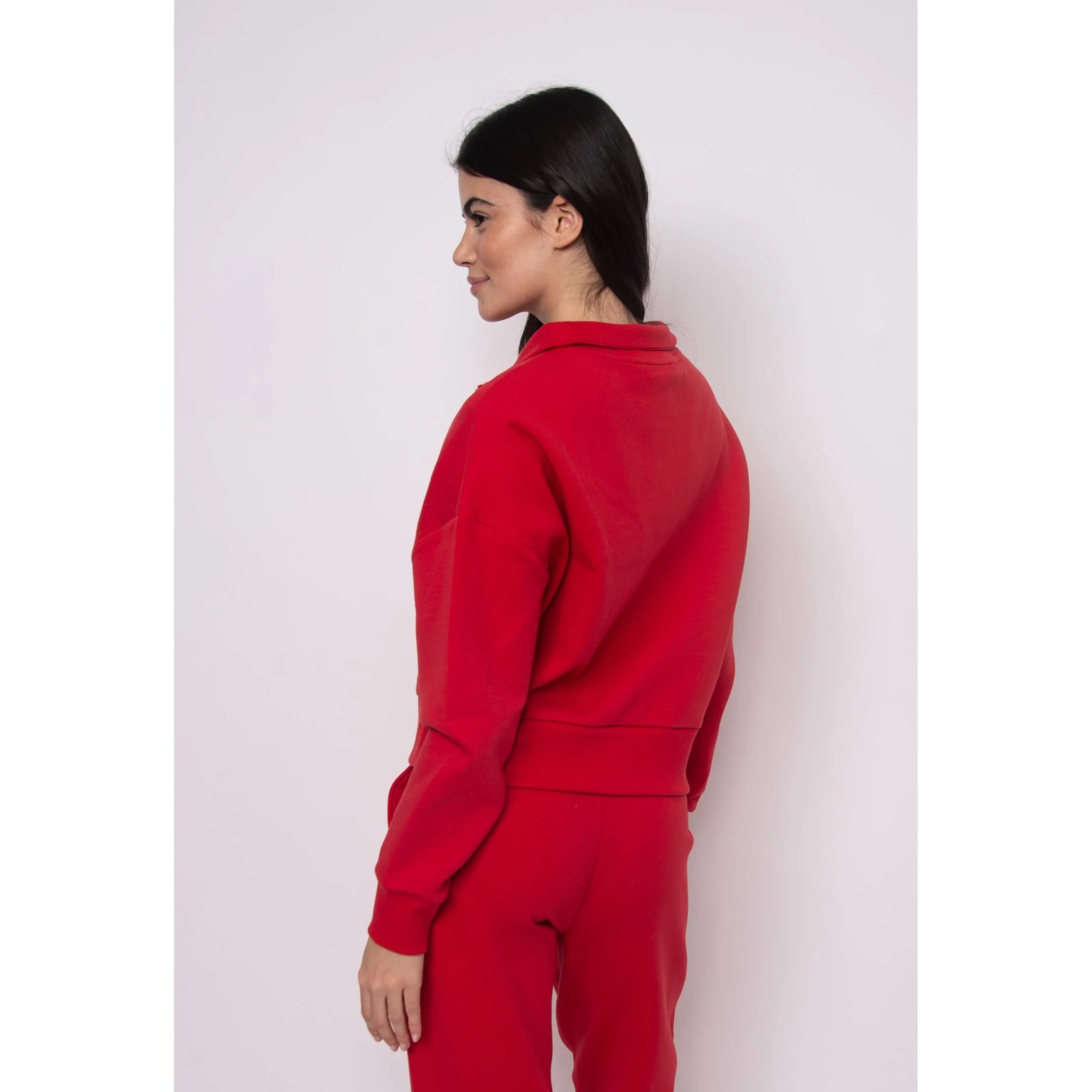 Seanni Soft Knit Half Zip Pullover worn by a model in red, side view showing cozy fall knit and relaxed fit.