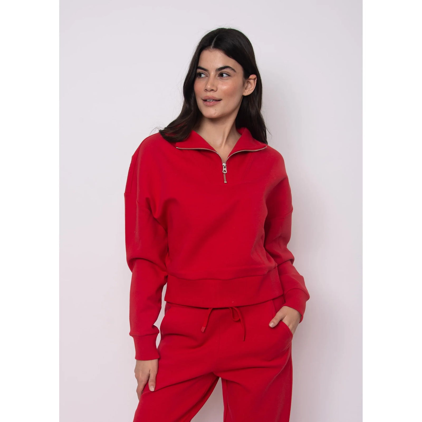 Model wearing Seanni Soft Knit Half Zip Pullover in red; cozy fall knit with zip collar.