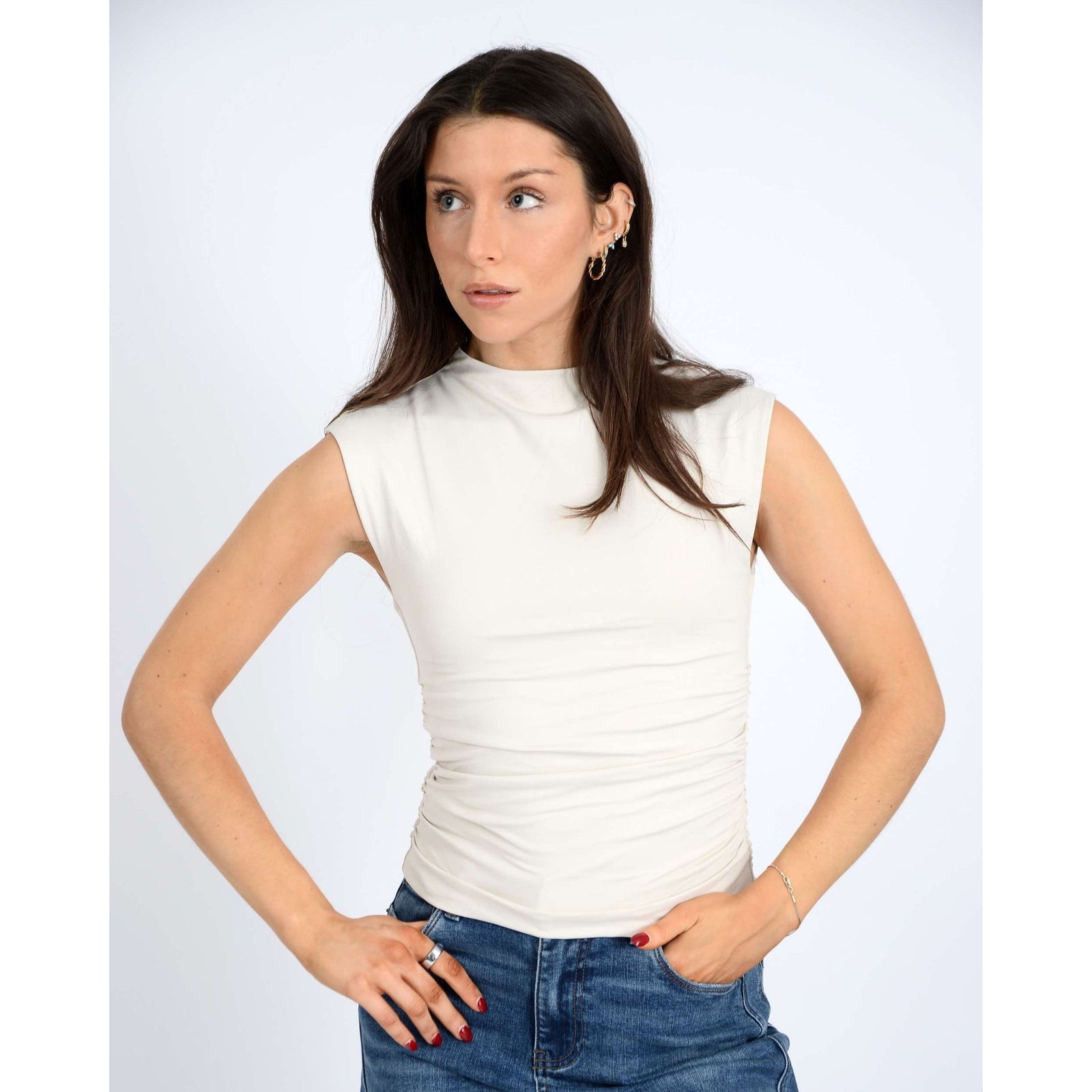 Chic model showcases the Second Skin Yve Mock Neck Ruched Tank in champagne, perfect for effortless style.