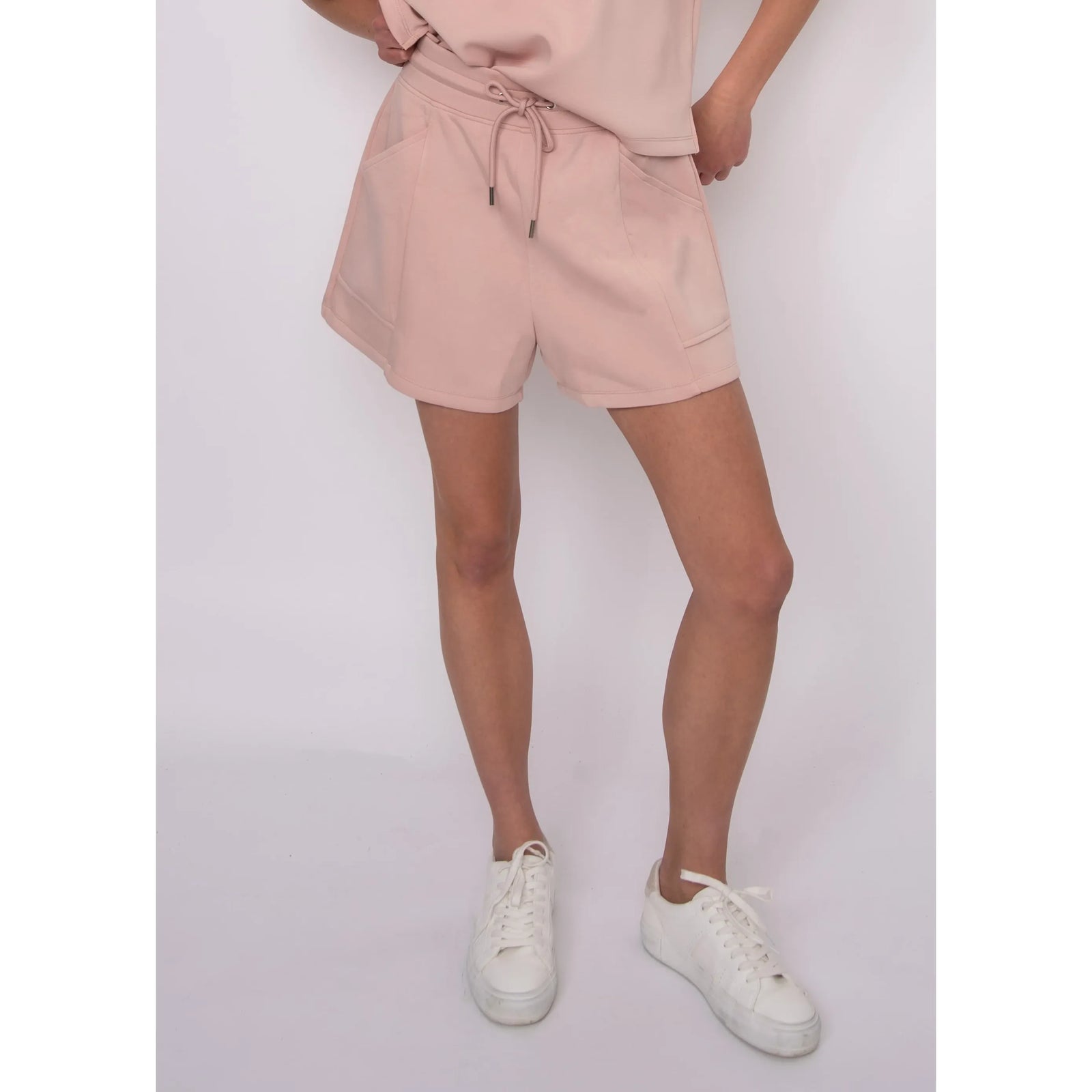 Senza Soft Knit Shorts in blush pink with pockets and drawstring, on a 5 ft 6 in model wearing size small.